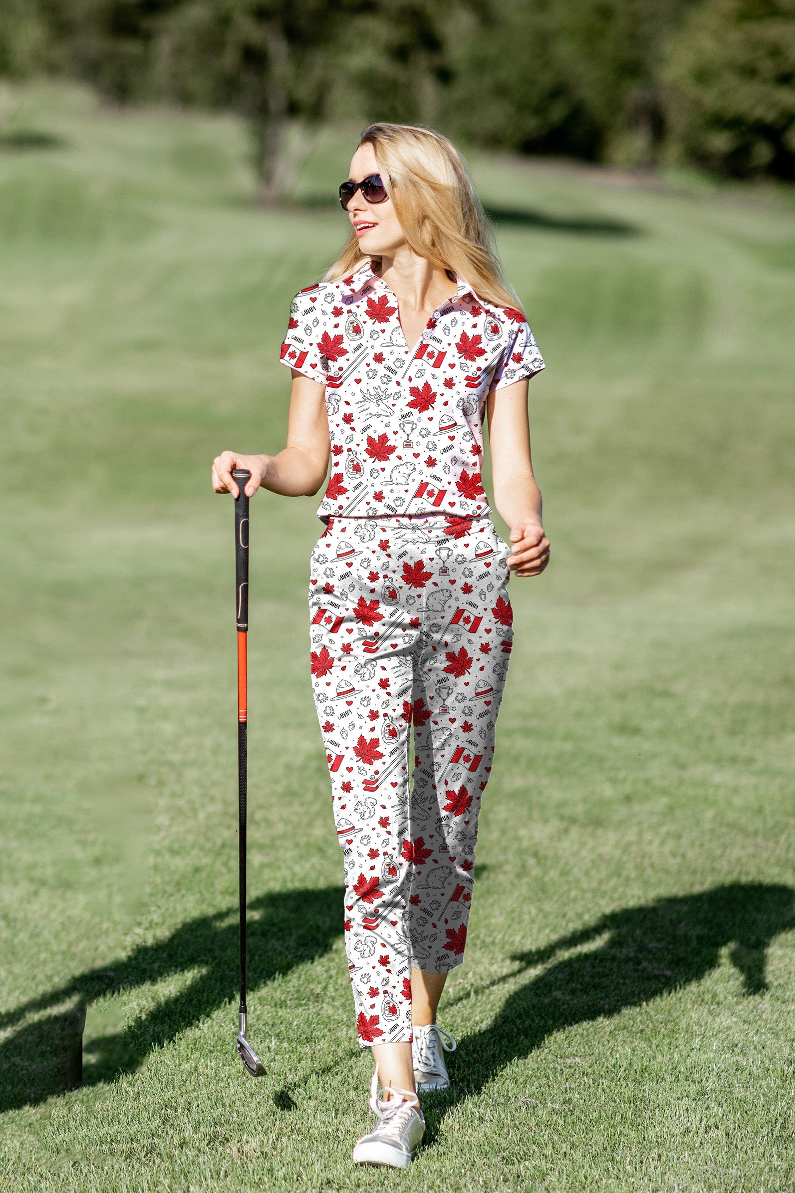 Woman wearing customized women's golf polo and pants set with Canadian balloon squirrel and maple leaves print on golf course