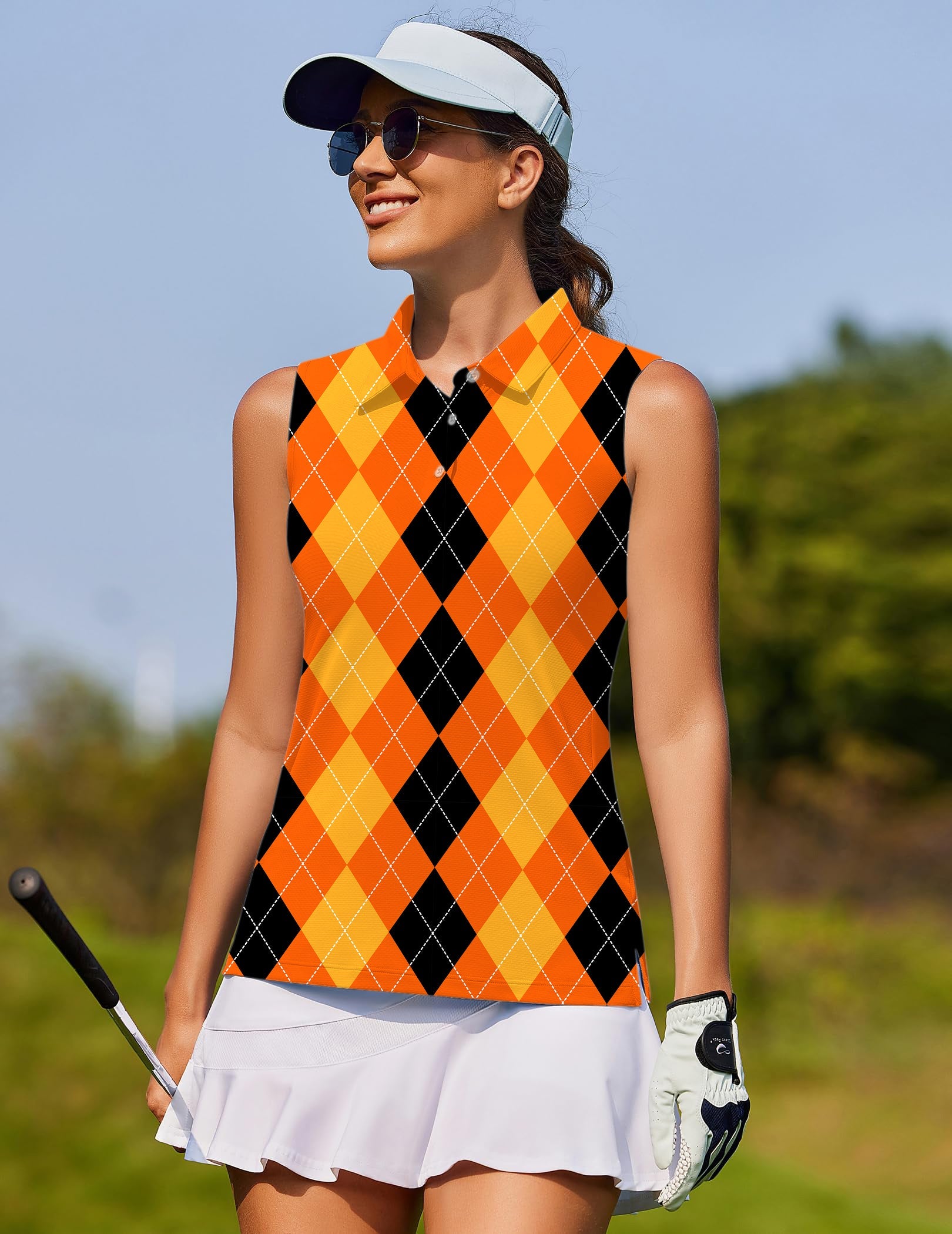 Halloween black yellow orange argyle women's sleeveless golf shirt on female golfer outdoors