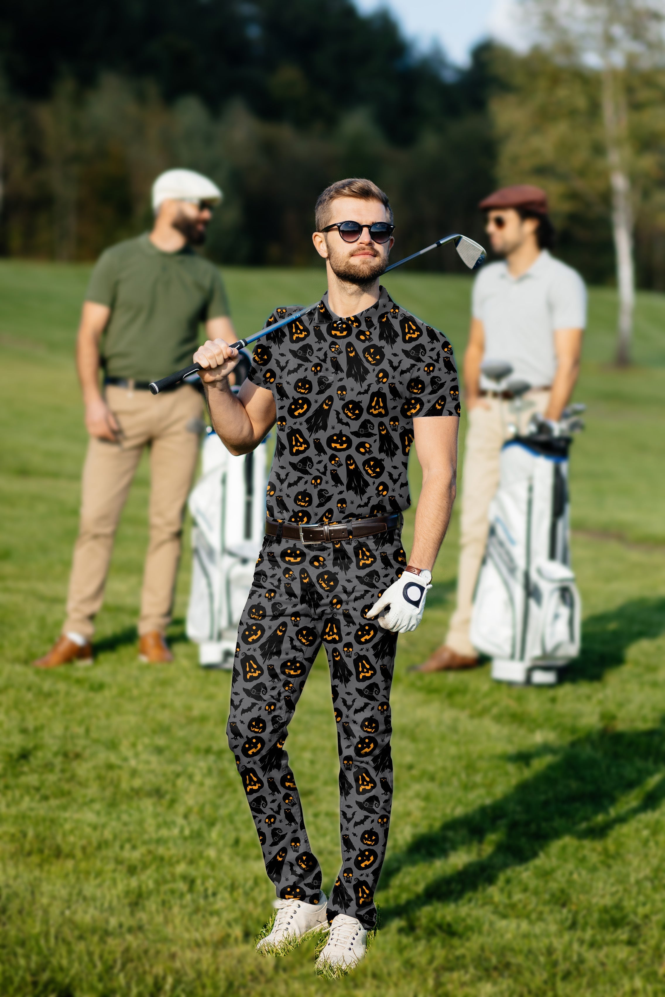 Men's Halloween themed golf set polo and pants with jack-o-lantern print on golf course