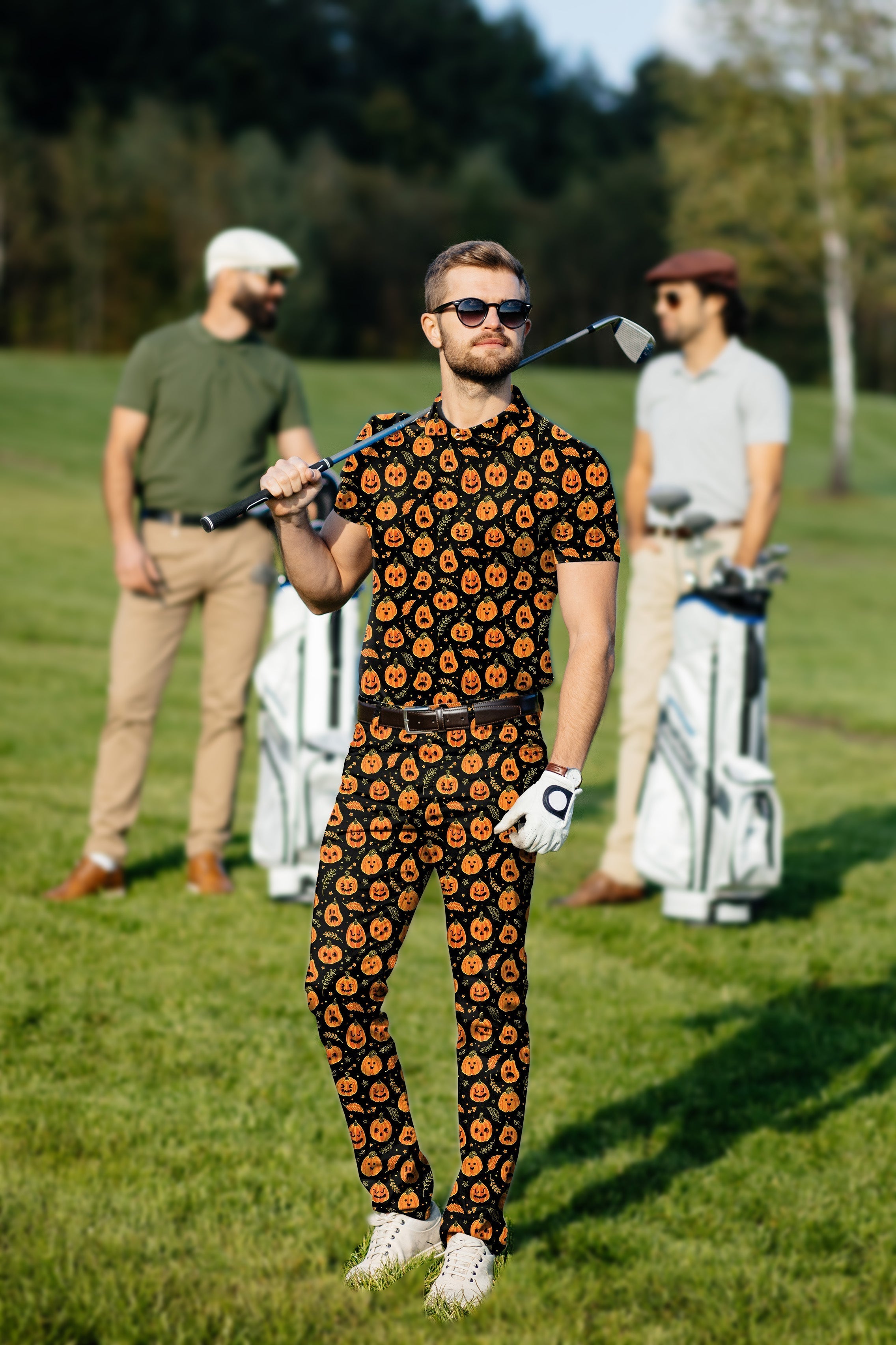 Men's golf set with Halloween pumpkin and bone pattern polo and pants on golfer on course