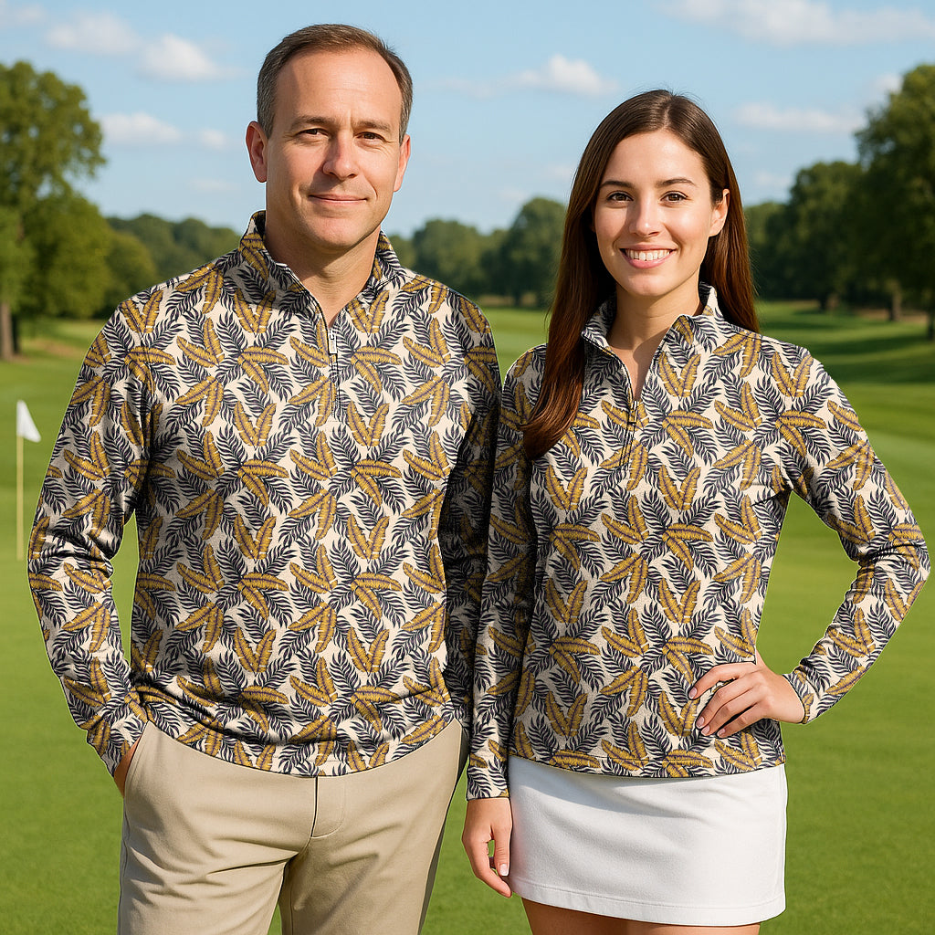 Couple wearing Golden Tropics long sleeve 3/4 zip golf tops with tropical leaf print on golf course