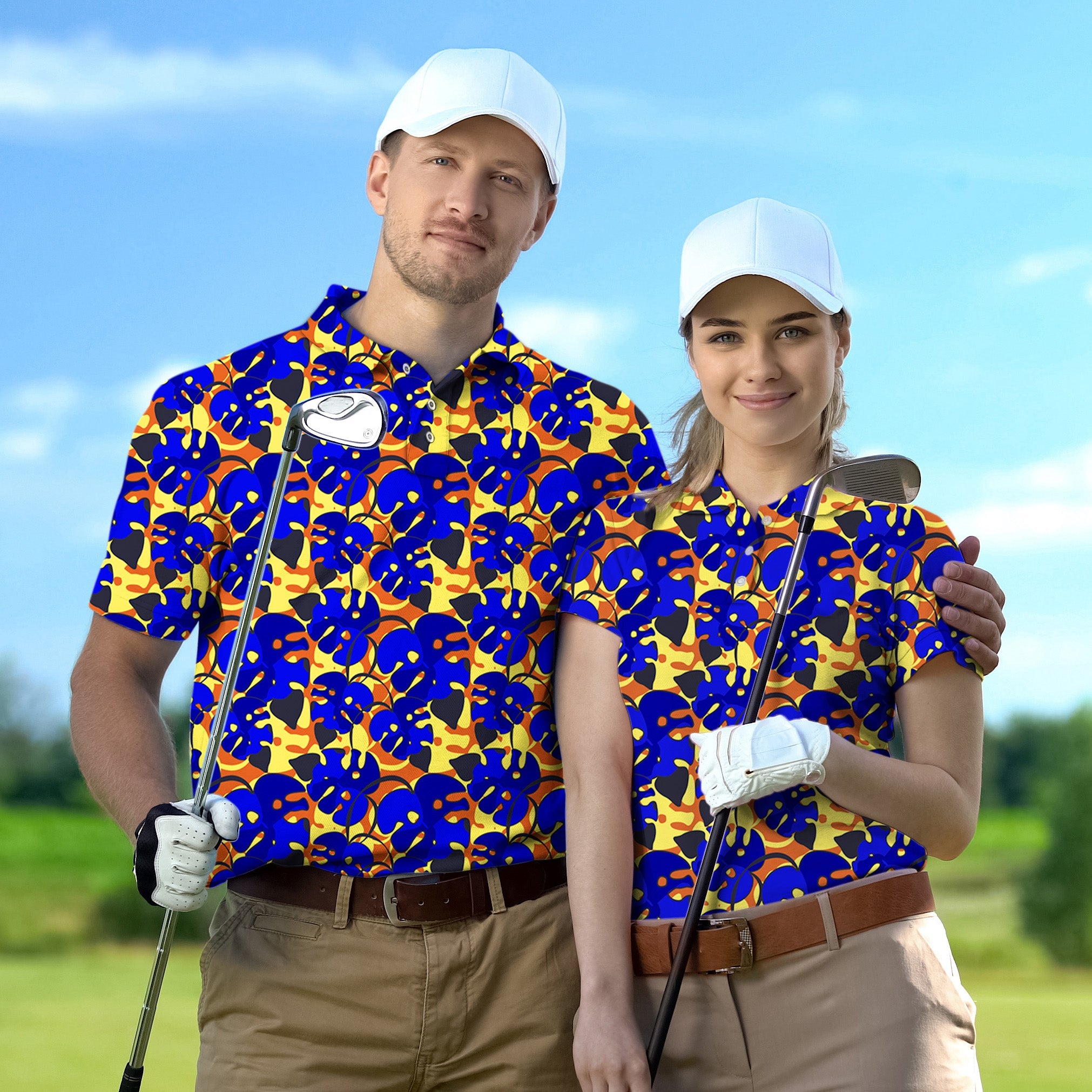 couple wearing tropical leaves patterned golf shirts with white caps holding golf clubs on golf course