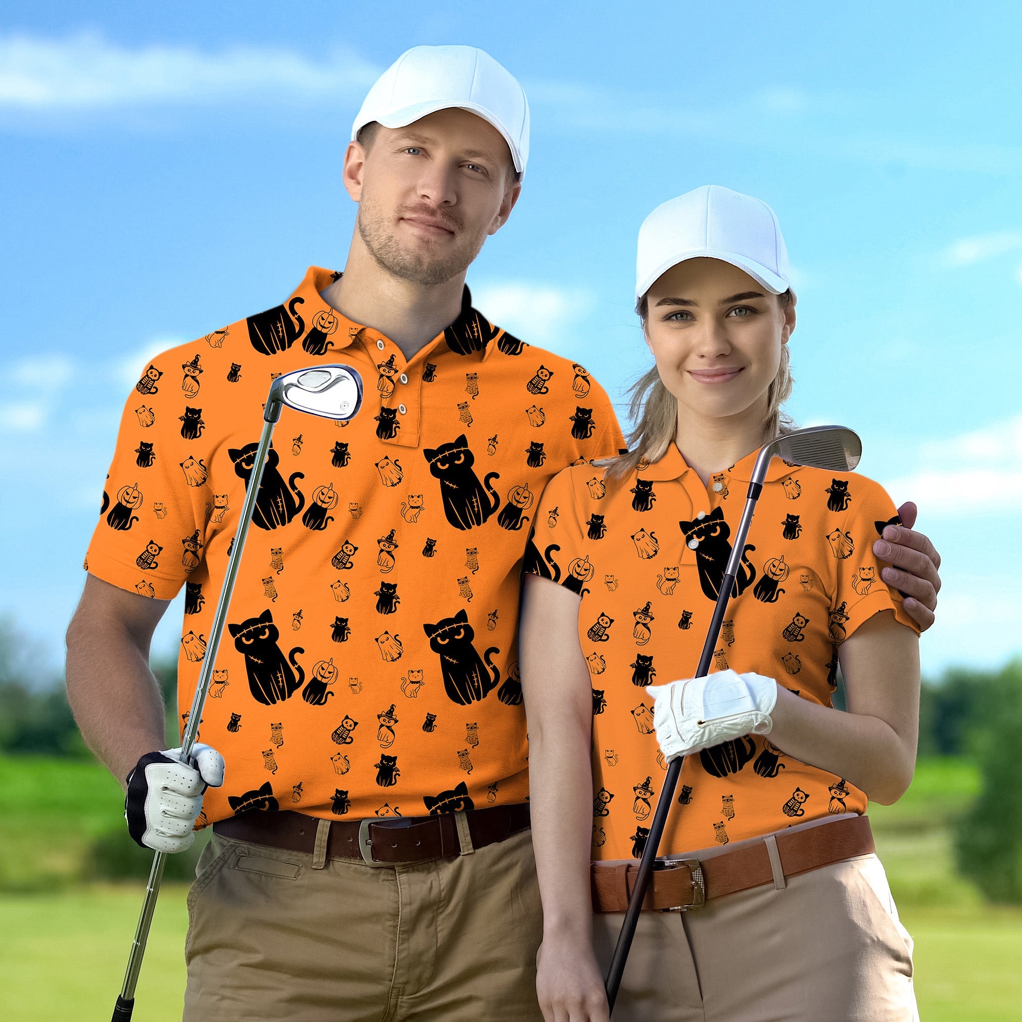 Couple wearing Halloween-themed orange golf shirts with black cat prints playing golf outdoors