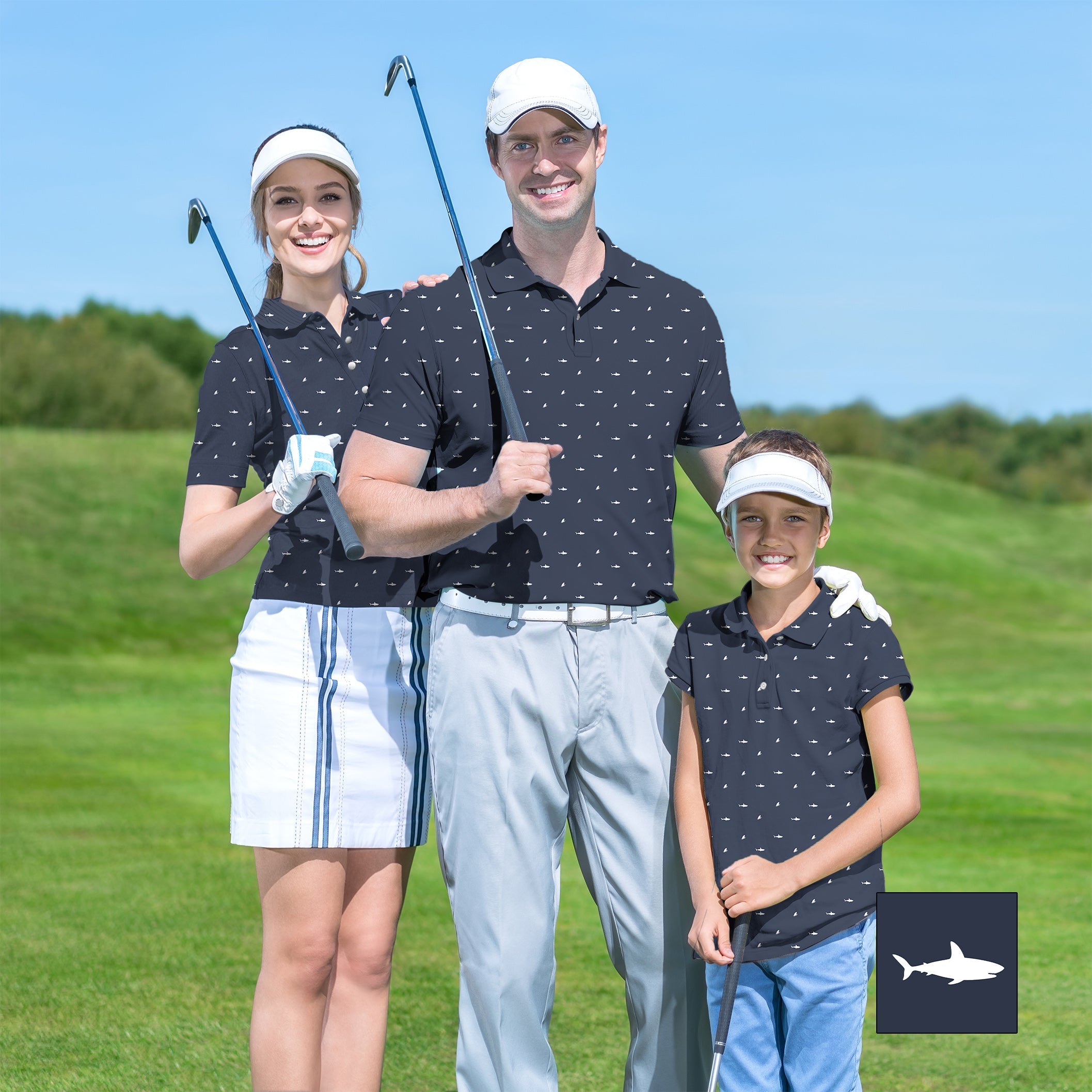 Family wearing matching white shark print golf shirts on green golf course