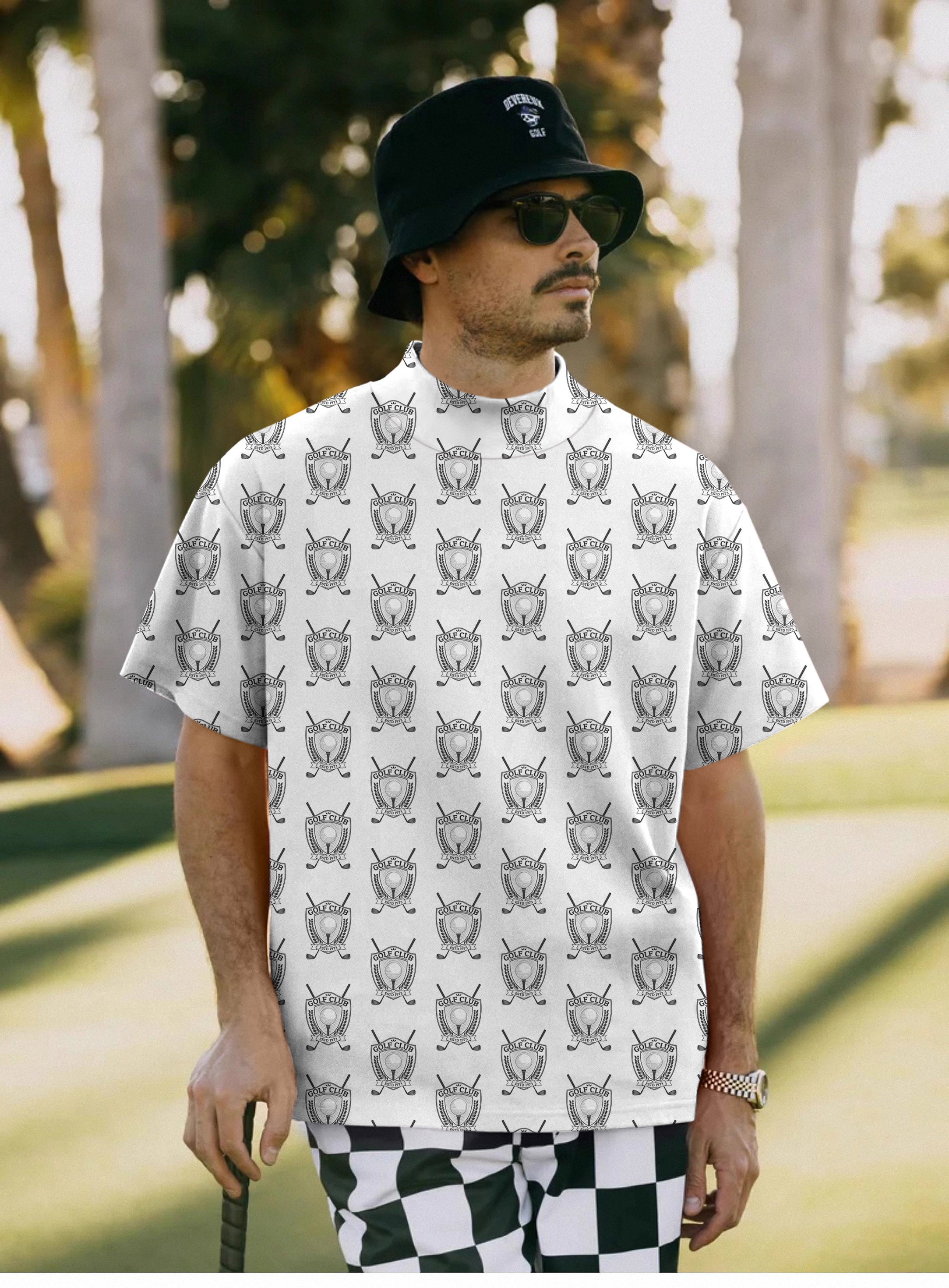 Men's Golf Club Pullover short sleeve T-shirt with golf-themed print and checkered pants outdoors
