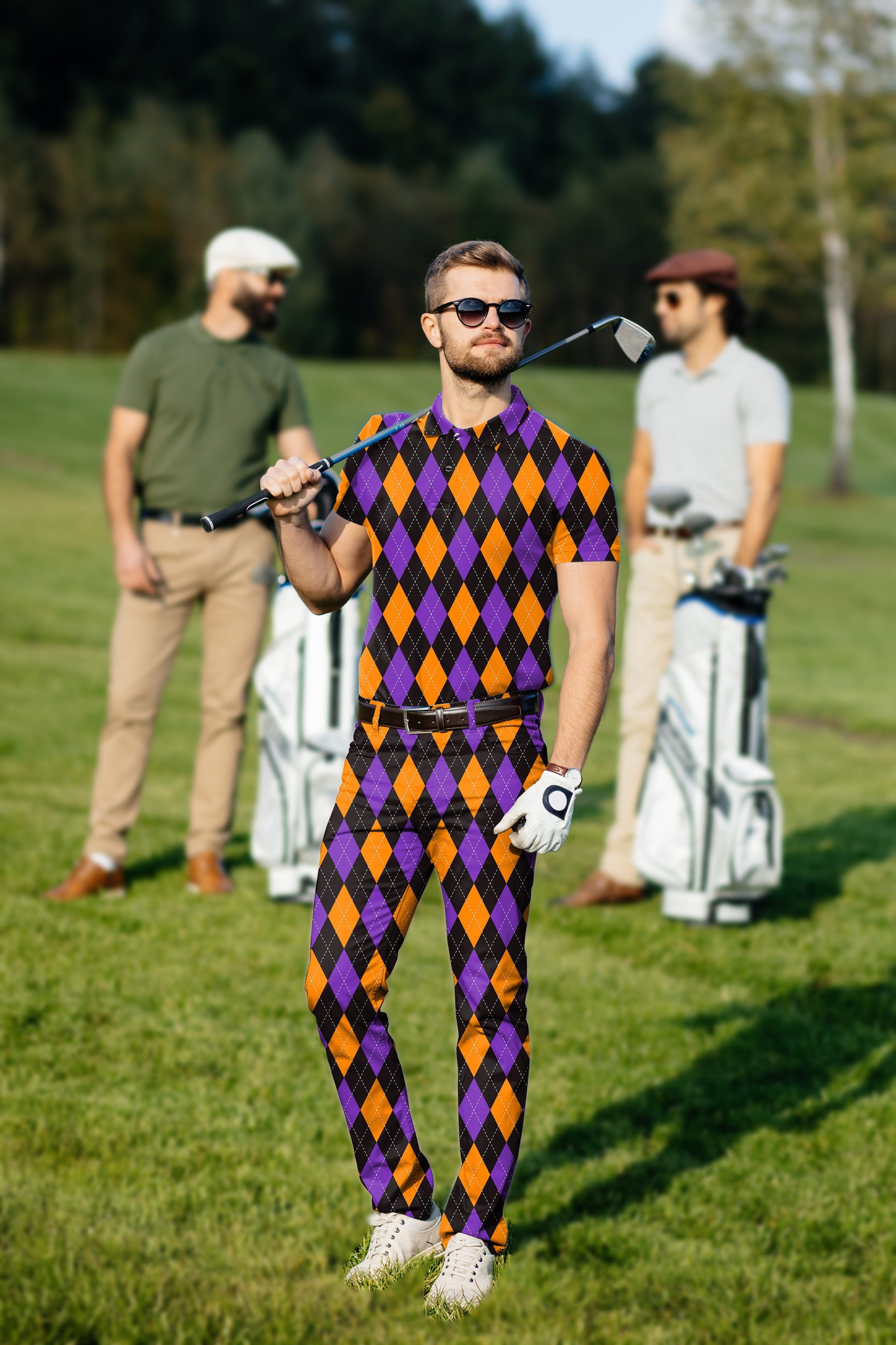 Men's golf set with orange, purple, and black argyle polo and pants, moisture-wicking and wrinkle-resistant fabric, tailored fit for comfort and style on the green