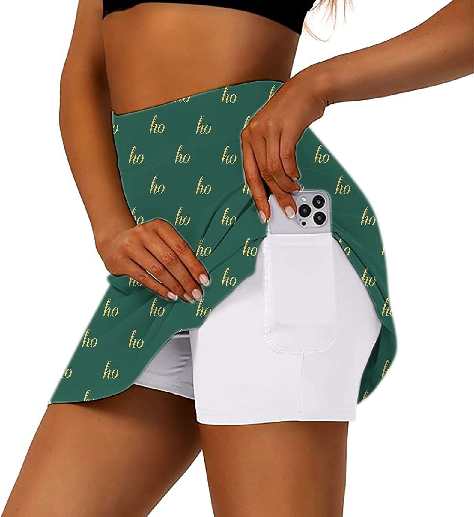 Dark green women's athletic golf skorts with custom name and Christmas "ho" print, featuring flared skirt and inner shorts with phone pocket