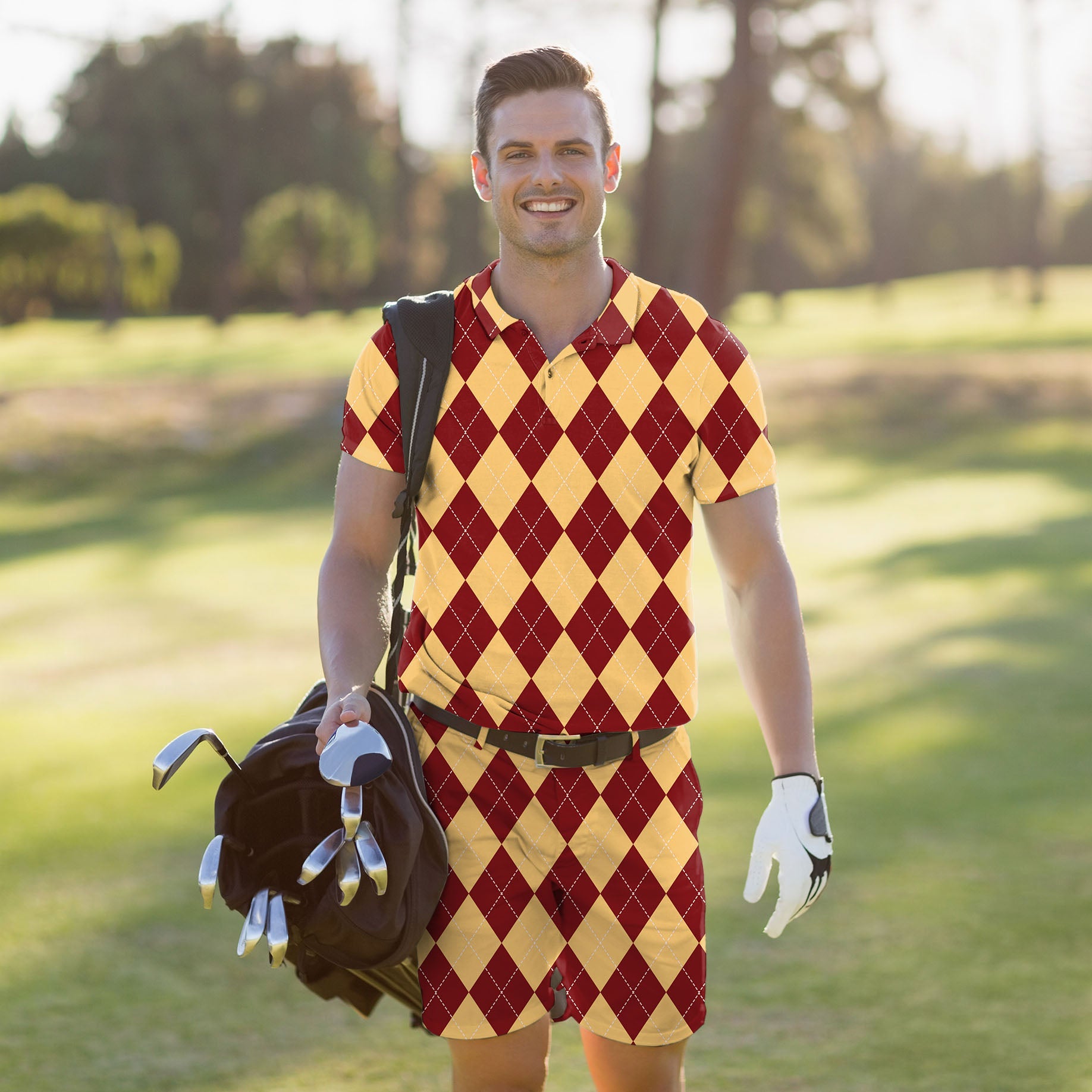 Men's golf set with yellow and red argyle polo and shorts on a golfer carrying a golf bag on a course