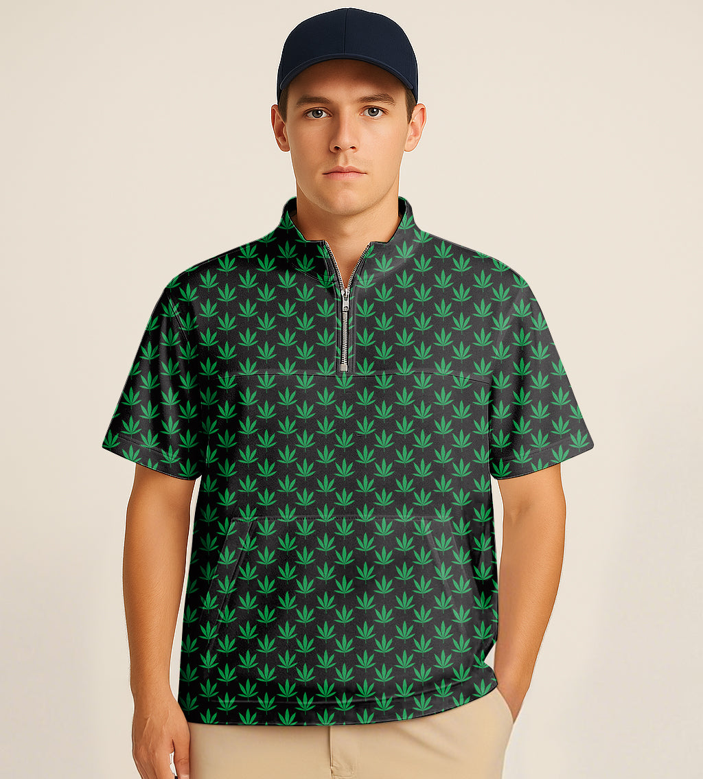 Man wearing half zipper turtleneck golf shirt with green leaf embroidery and navy cap