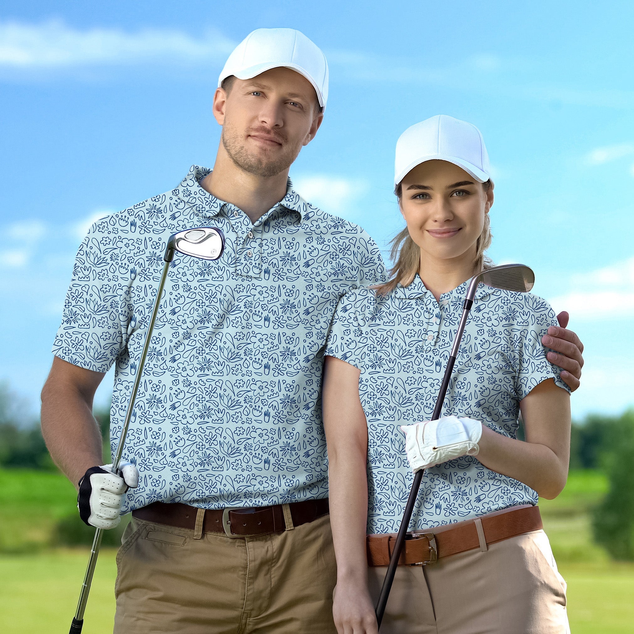 Couple wearing simple blue flower drawing set golf shirts posing with golf clubs outdoors