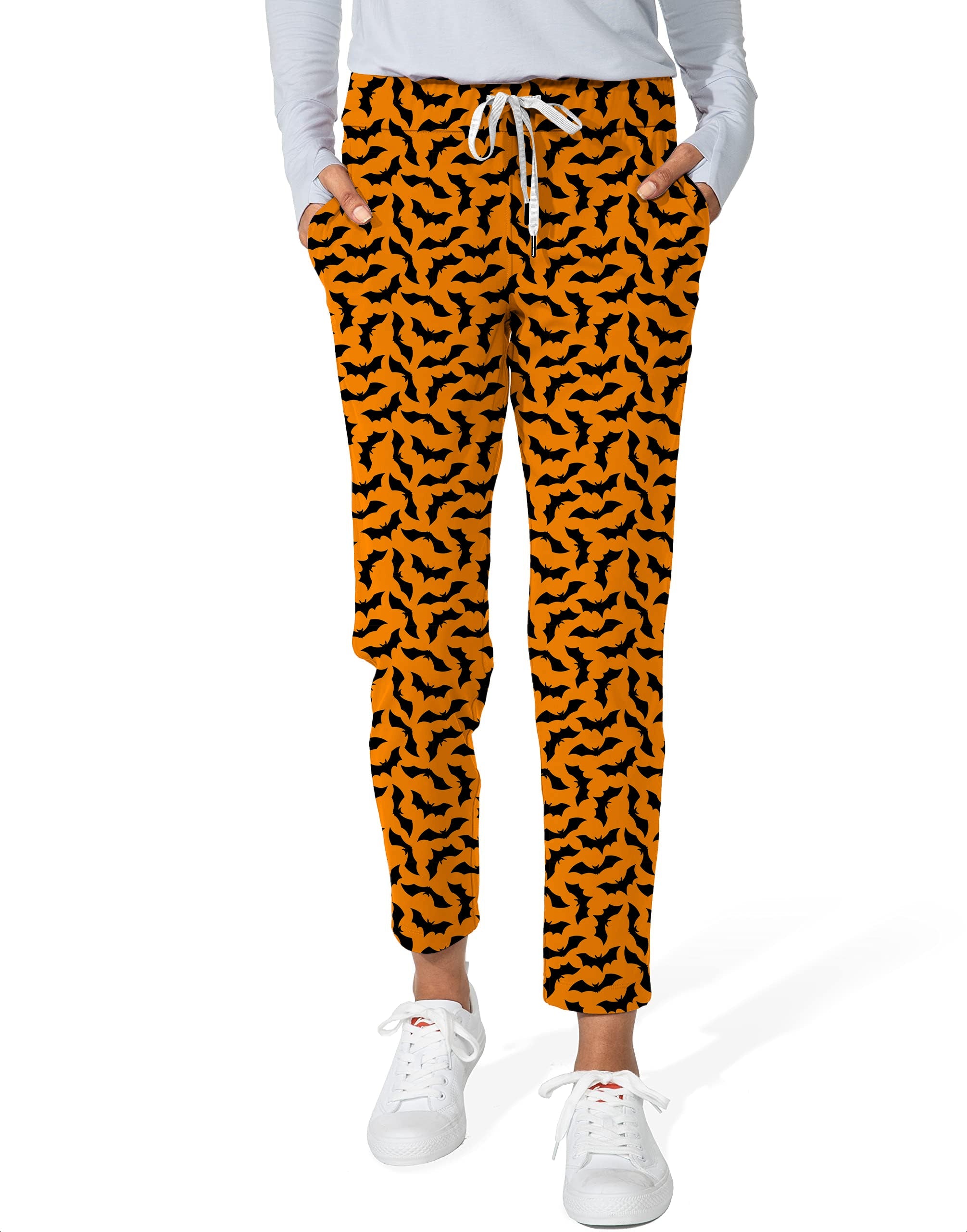 Women's 7/8 stretch ankle golf pants with custom Halloween bat pattern on orange background