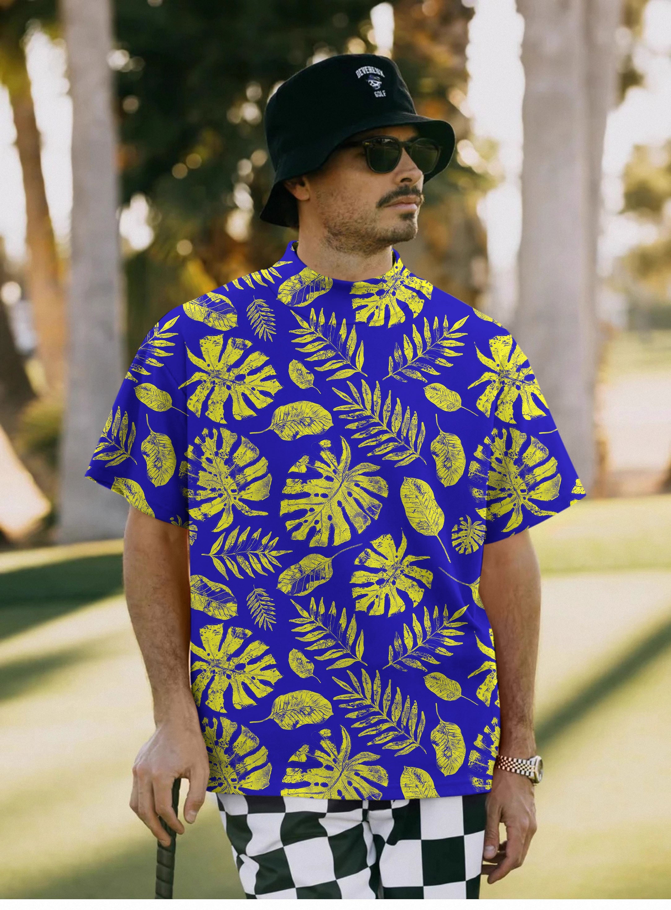 Men's Tropical plants Pullover with yellow tropical leaf print on blue short sleeve shirt worn outdoors