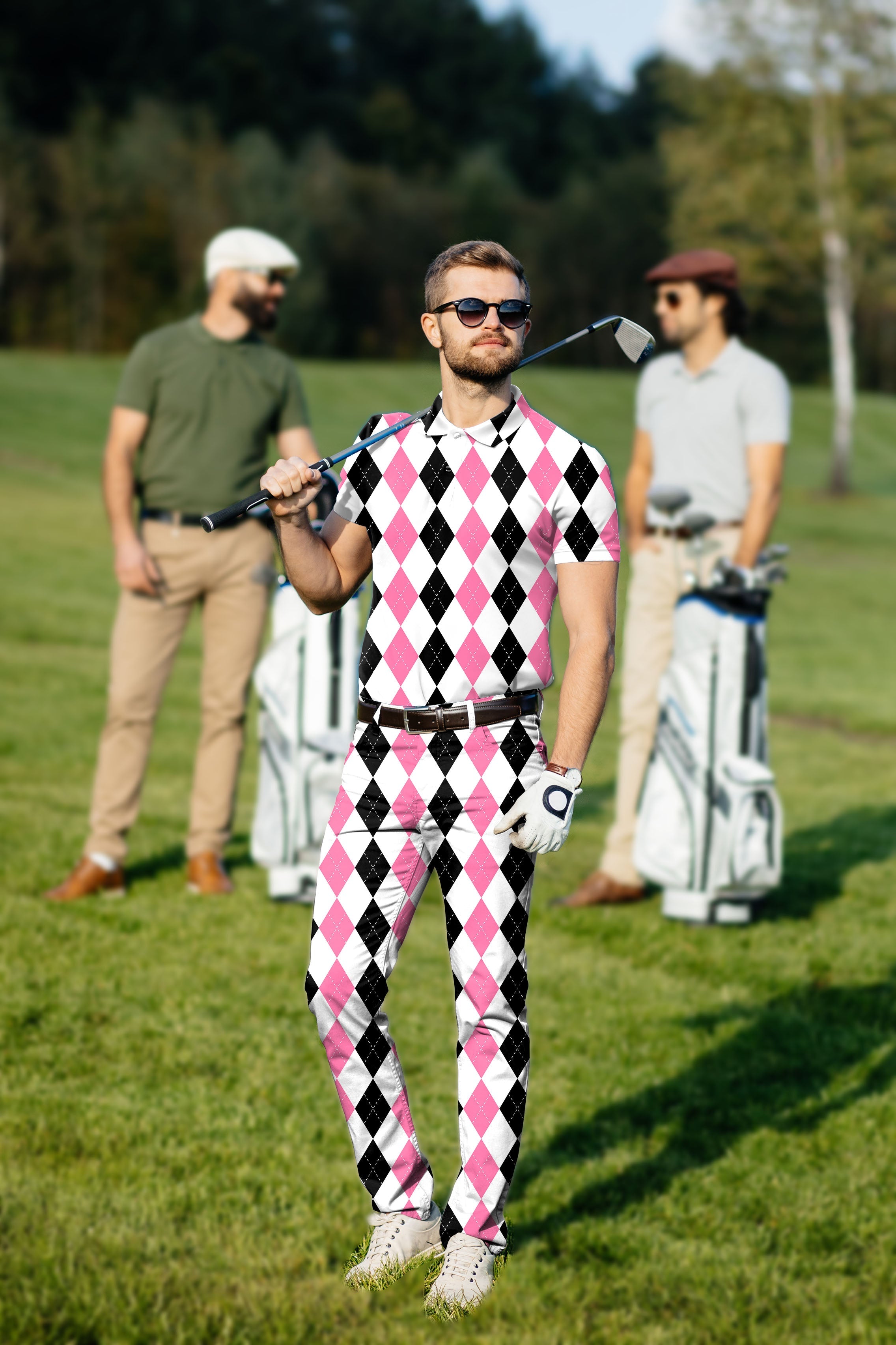 Men's golf set polo and pants in pink and black argyle pattern on golfer outdoors