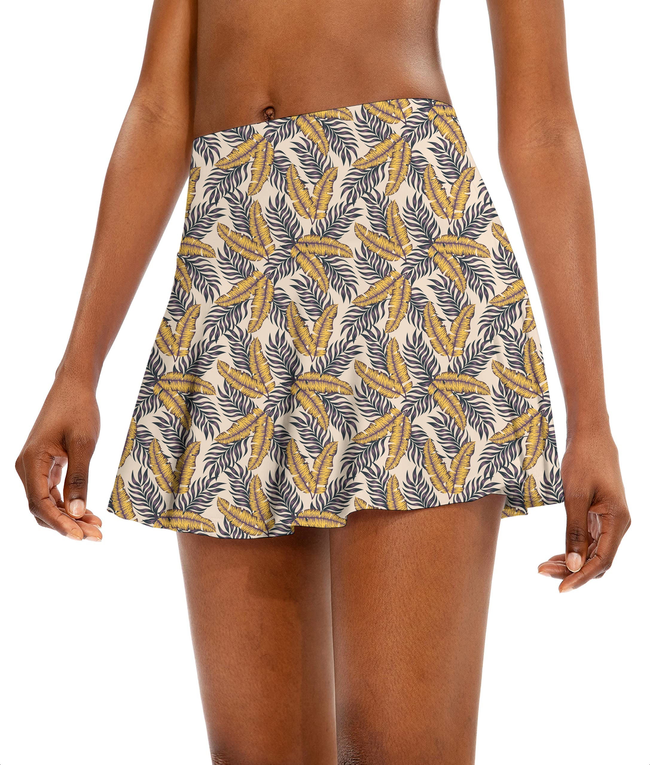 Golden Tropics Women's athletic golf skort with flared tropical leaf pattern
