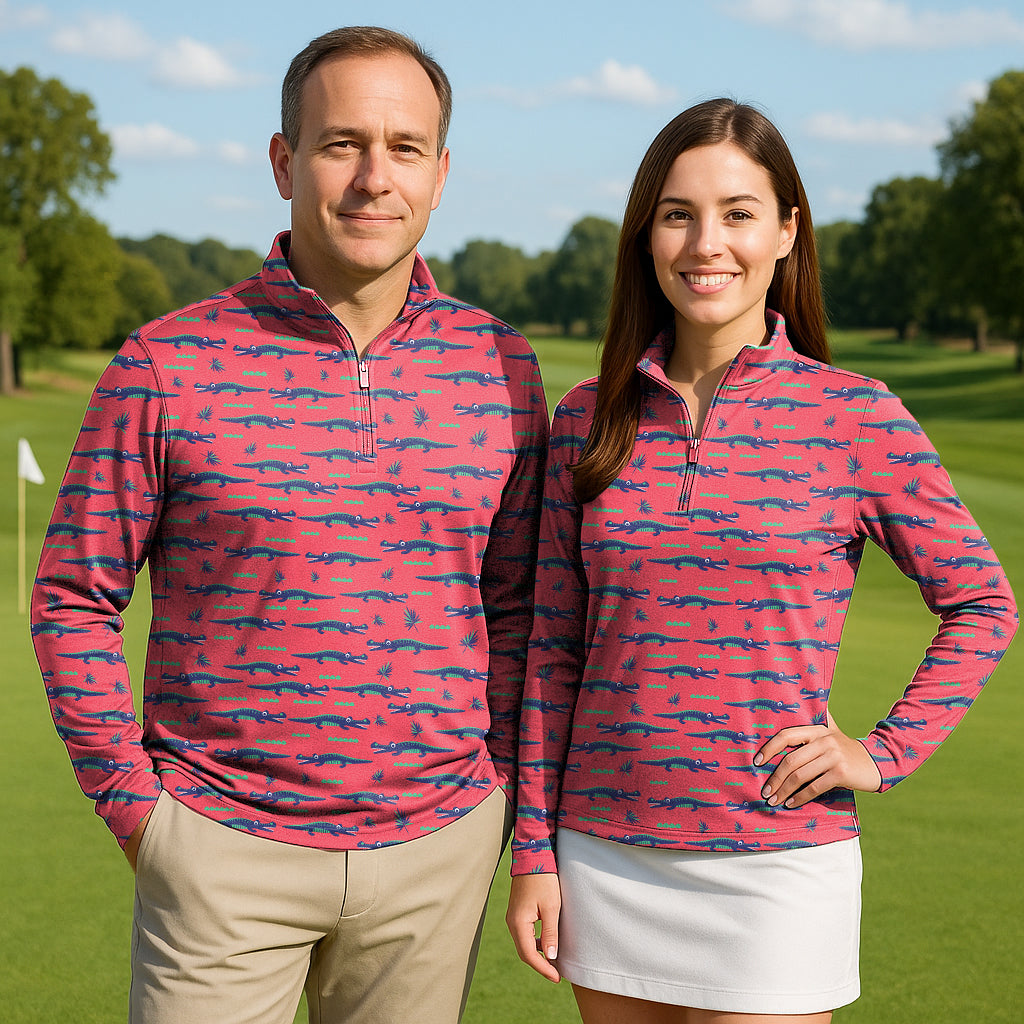 Couple wearing pink crocodile print 3/4 zip active golf tops with long sleeves on golf course
