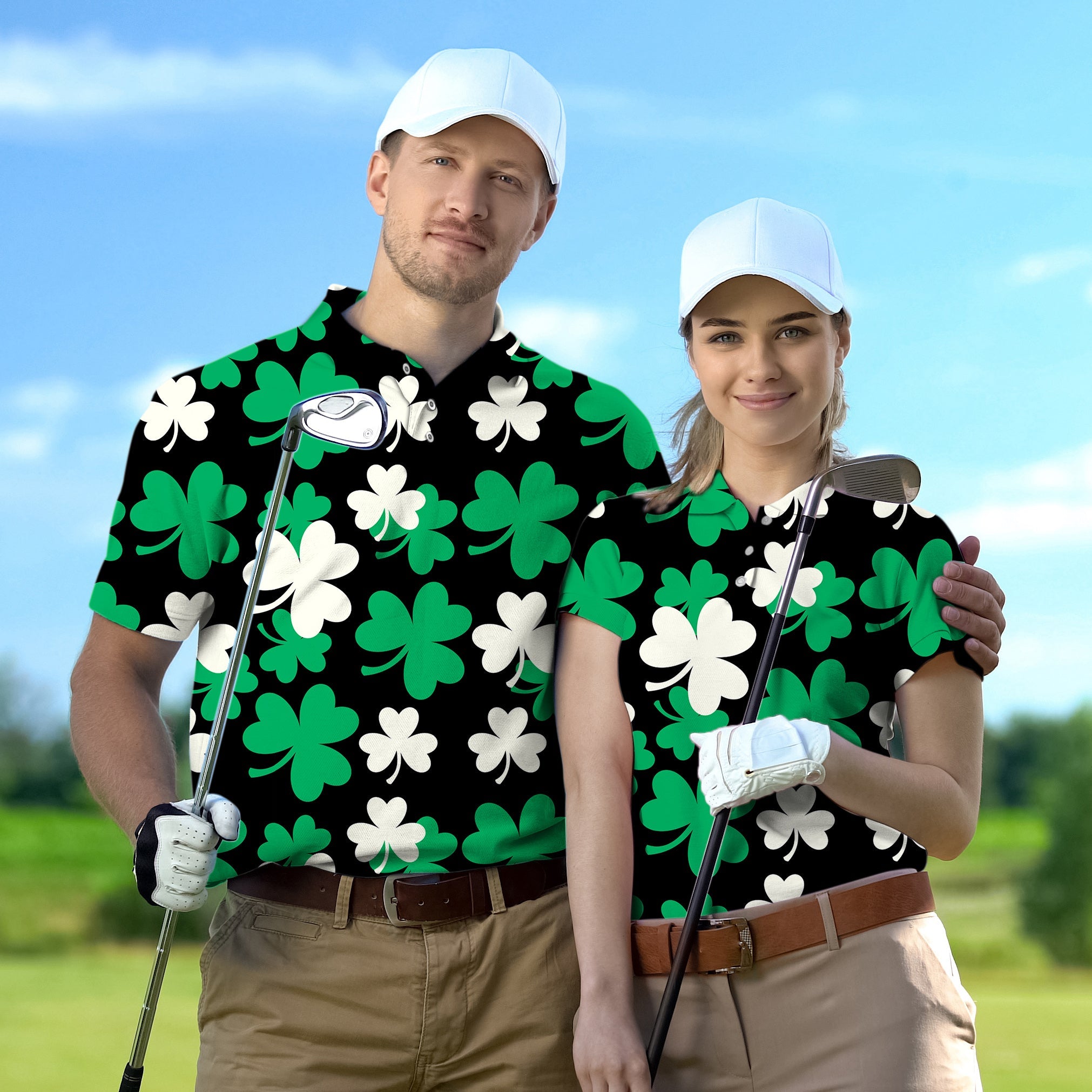 Couple wearing black golf shirts with green and white leaf clover patterns and white caps on golf course