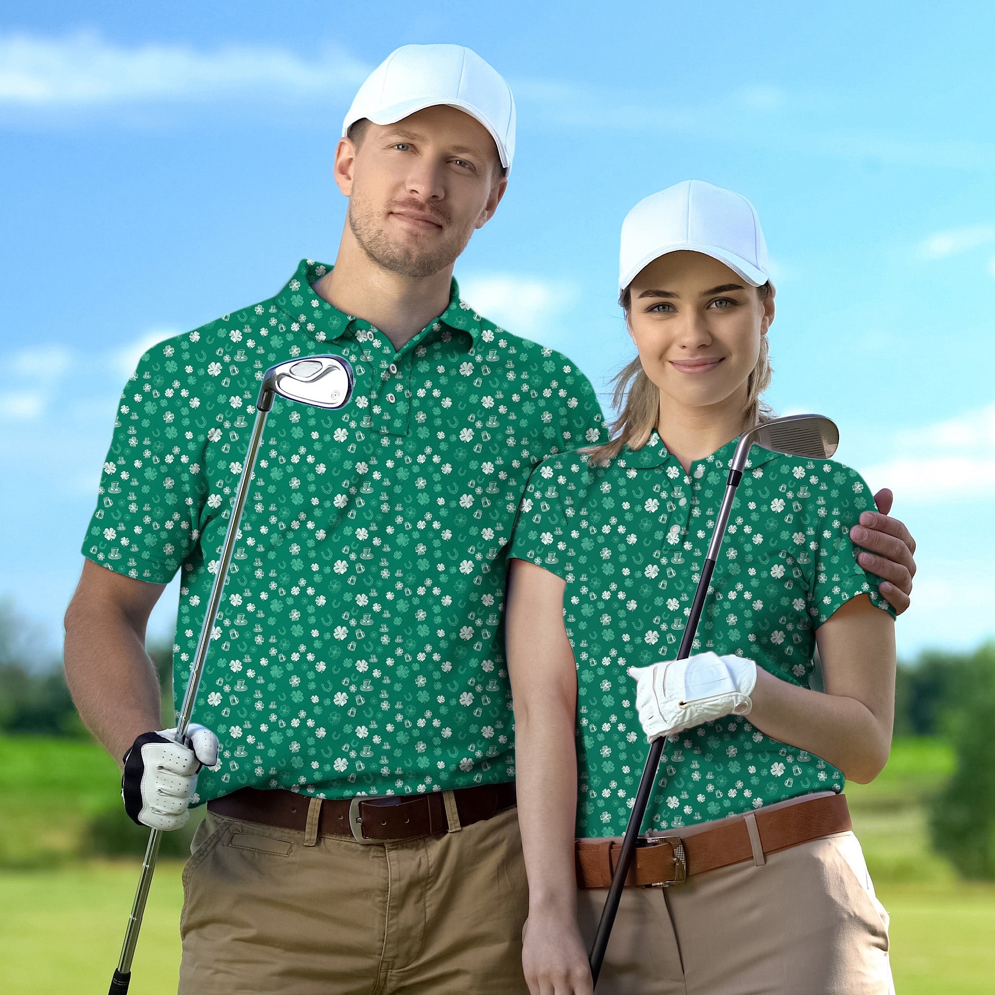 Couple wearing green clover leaf golf polo shirts with white caps holding golf clubs on a golf course