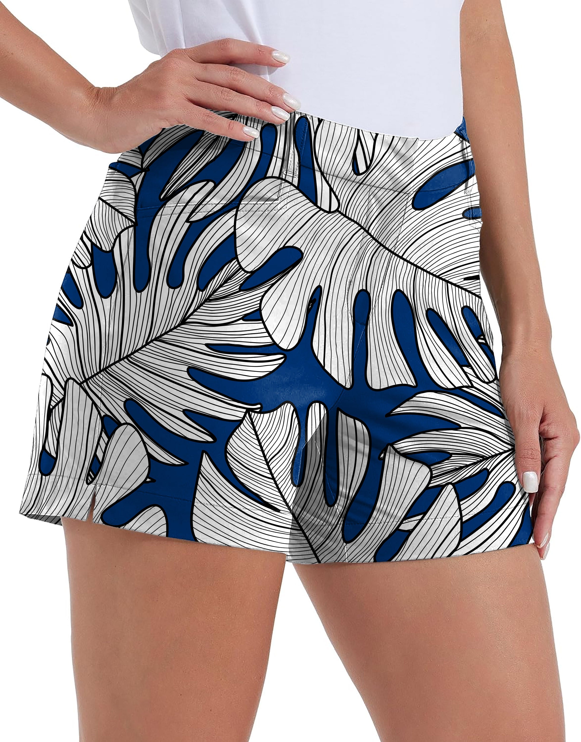Womens quick-drying golf shorts with blue and white floral split-leaf philodendron pattern and pockets