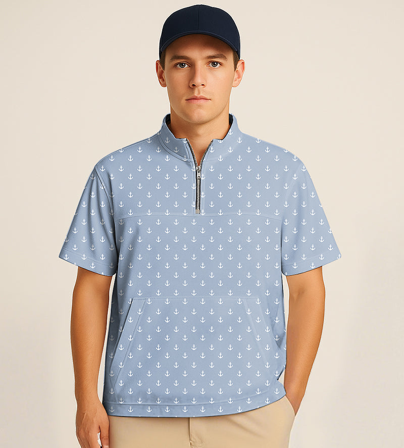 Man wearing blue half zipper turtleneck golf shirt with white anchor embroidery and navy cap
