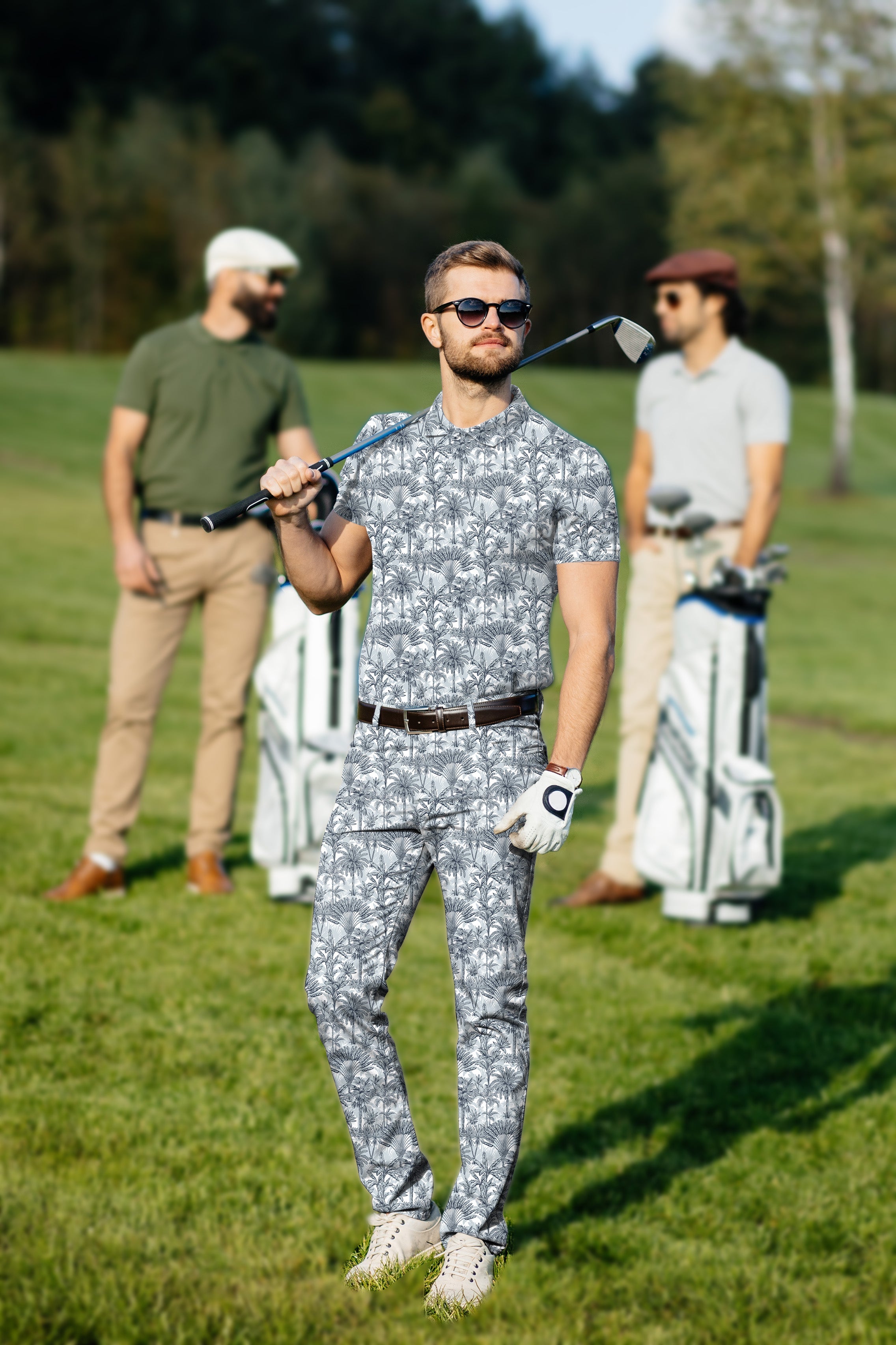 Men's golf set featuring breathable polo and pants with a twilight palms print, designed for comfort and style on the course