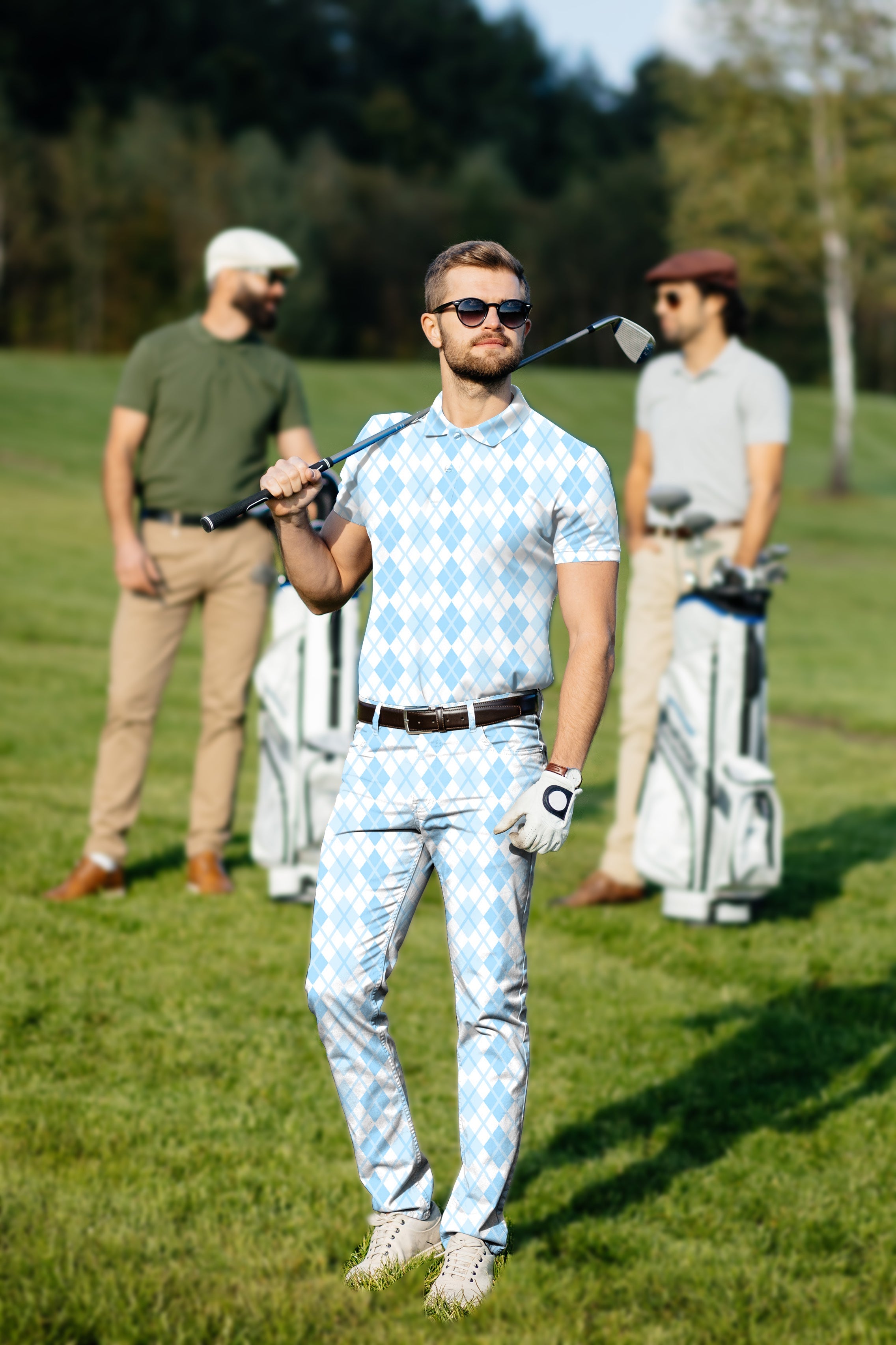 Men's golf set with blue argyle grid polo and pants on a sunny golf course