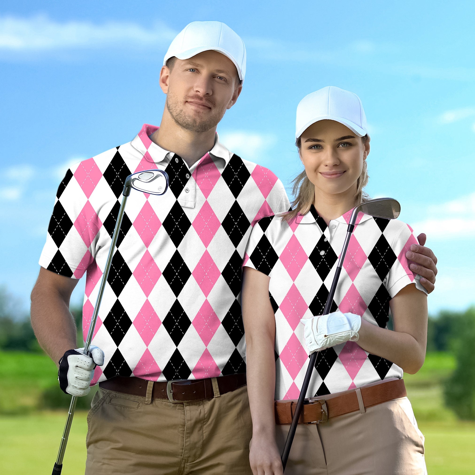 couple wearing pink black argyle golf shirts with white caps on golf course
