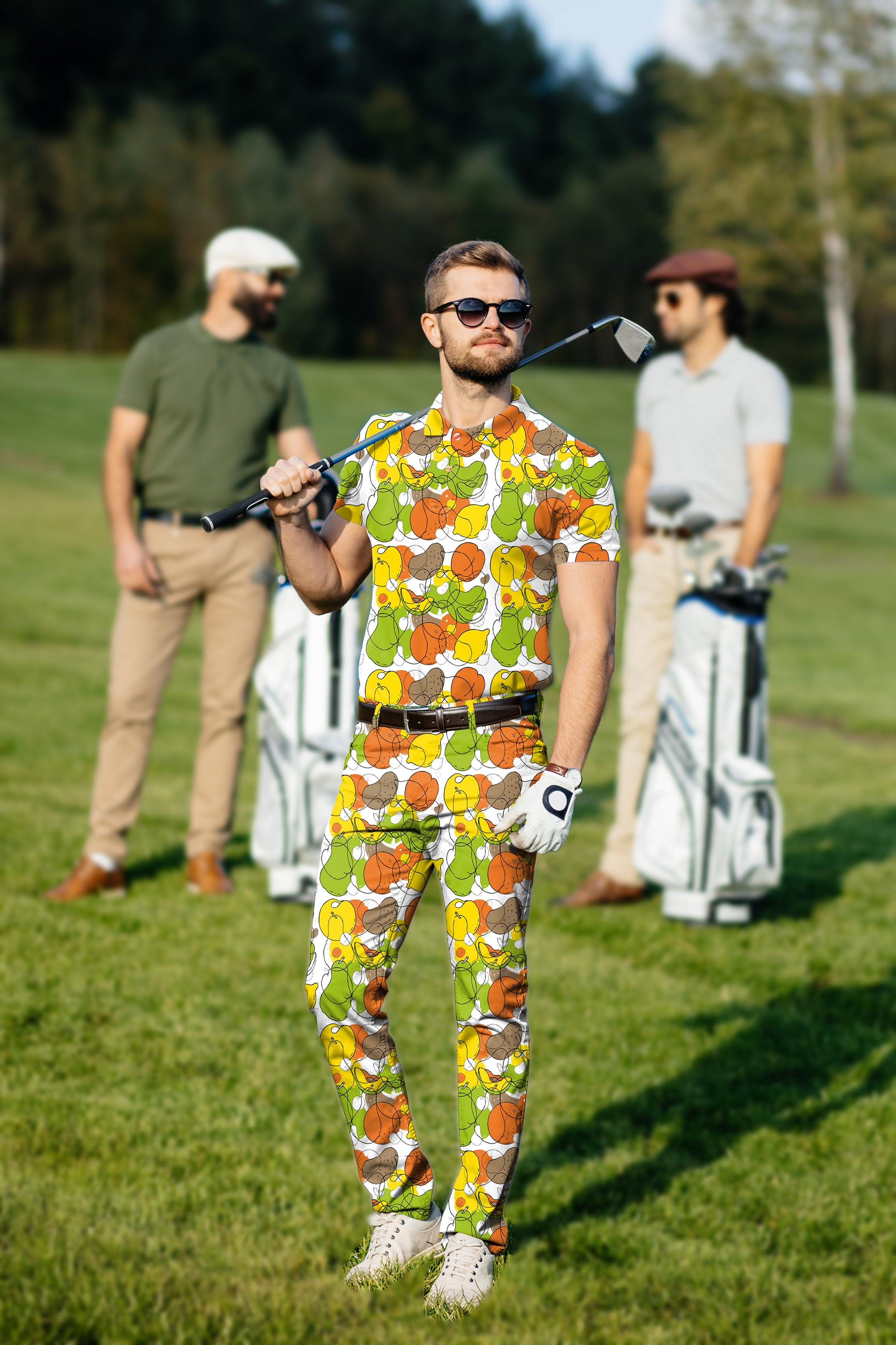 Men's golf set with colorful fruit print polo and pants, tailored fit, moisture-wicking, and UPF 40+ protection.