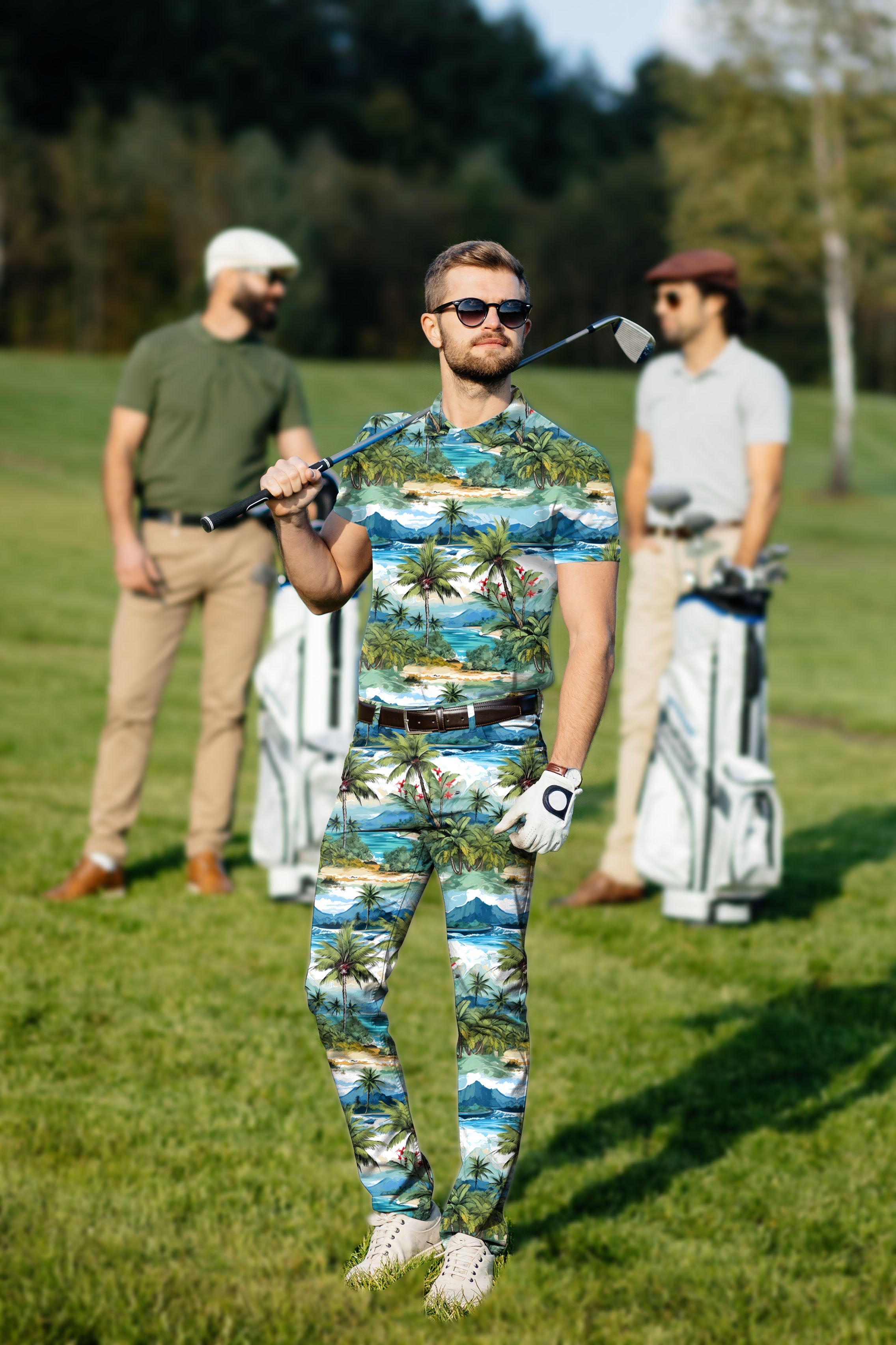 Men's golf set with Hawaii palm tree print polo and pants on golfer with sunglasses on golf course