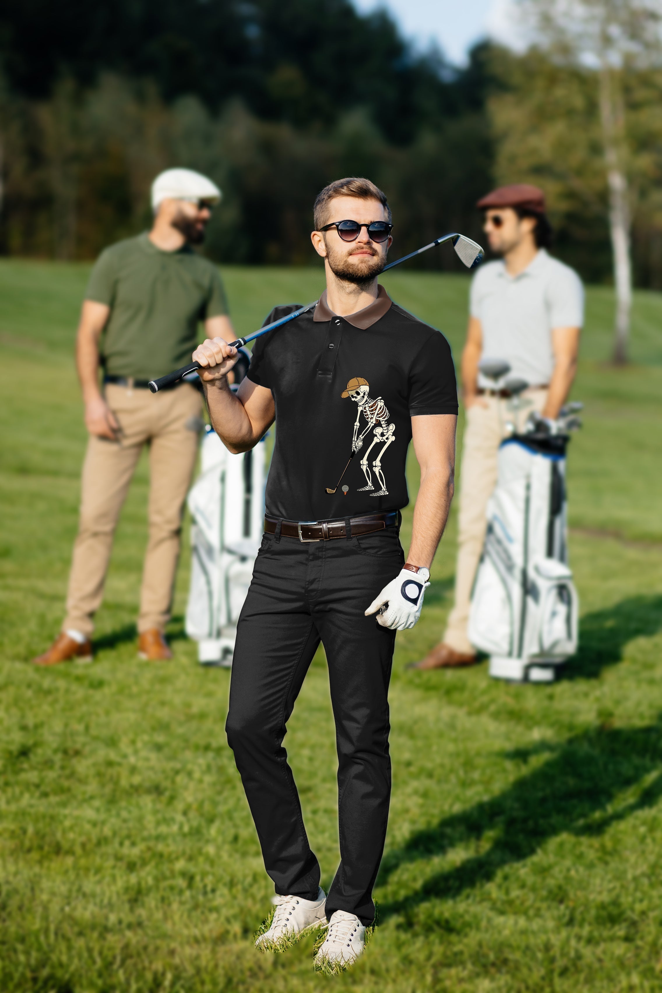 Men's golf set with black polo featuring skeleton design and matching pants on golf course