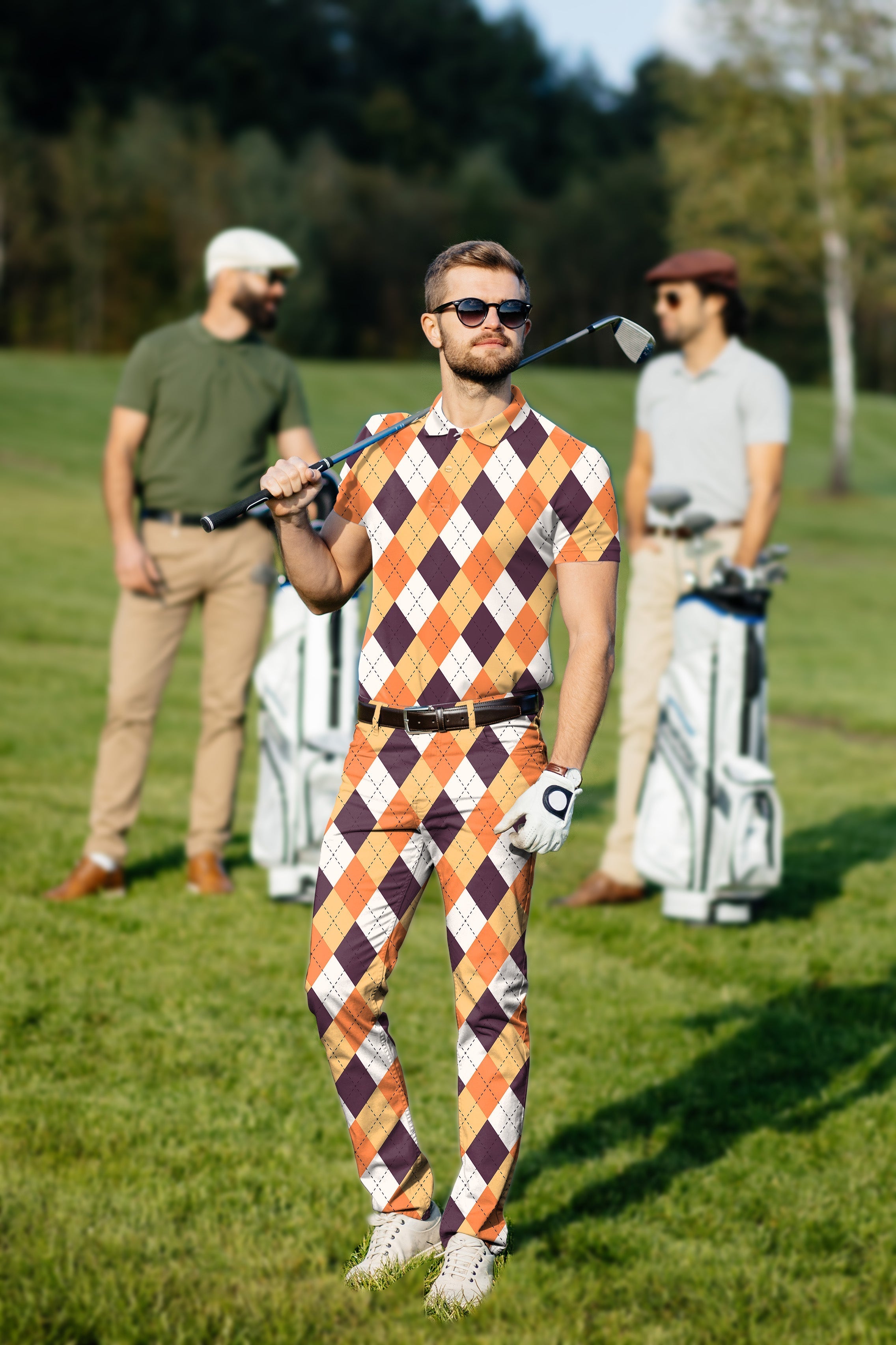 Men's golf set with Halloween orange white brown argyle polo and pants on golf course
