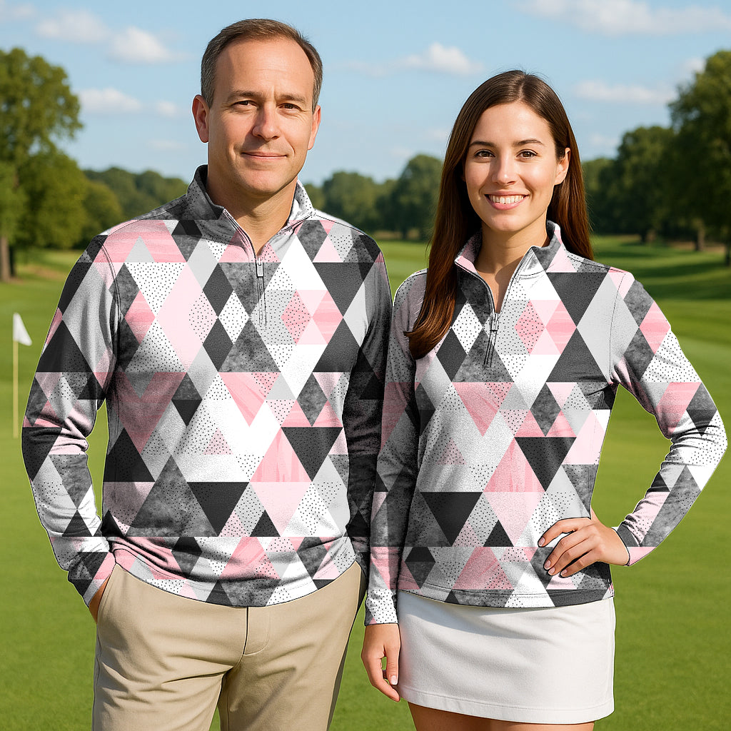 Couple wearing On Par Sale golf active 3/4 zip tops with pink, black, and white geometric patterns on a golf course