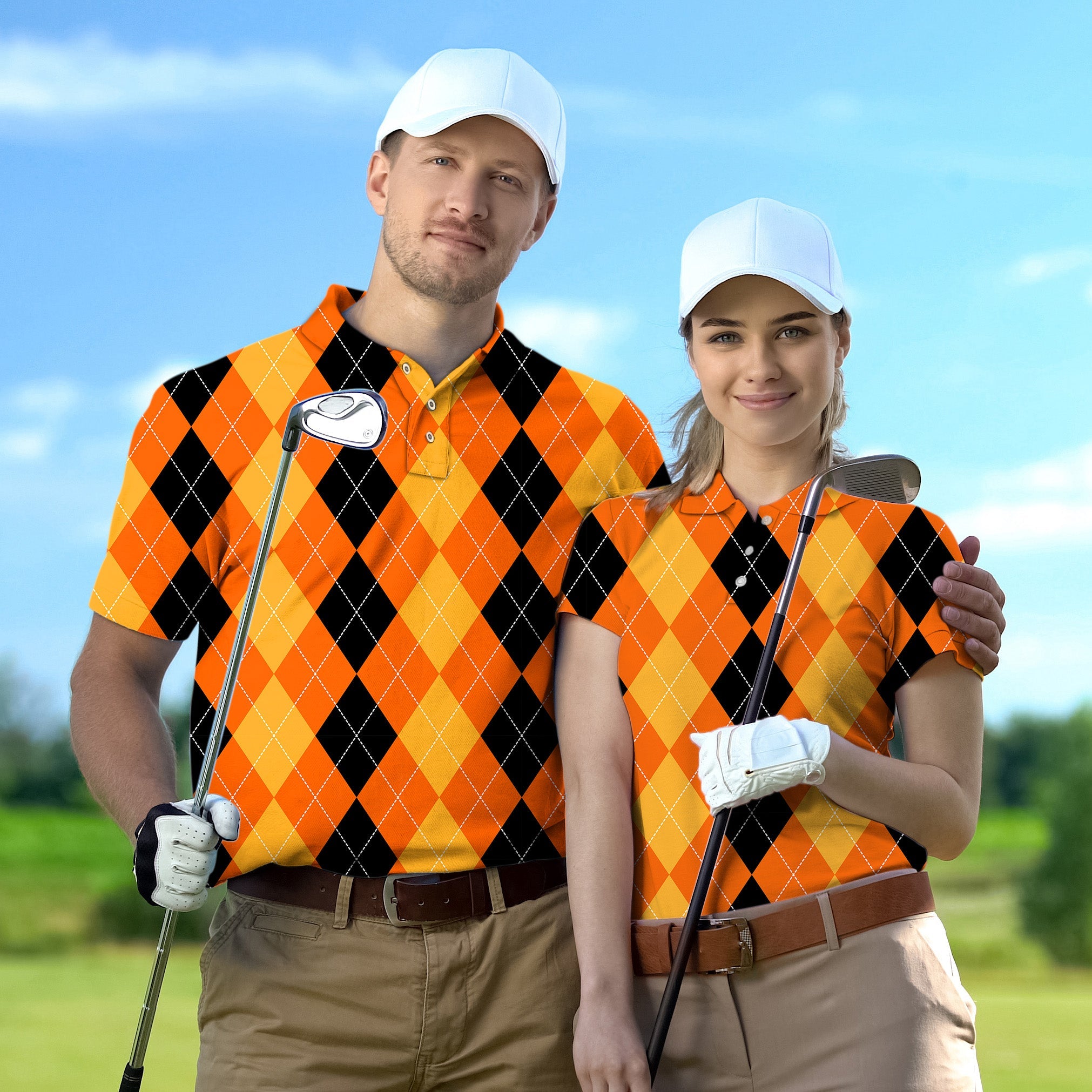 Couple wearing Halloween black yellow orange argyle golf shirts holding clubs on golf course