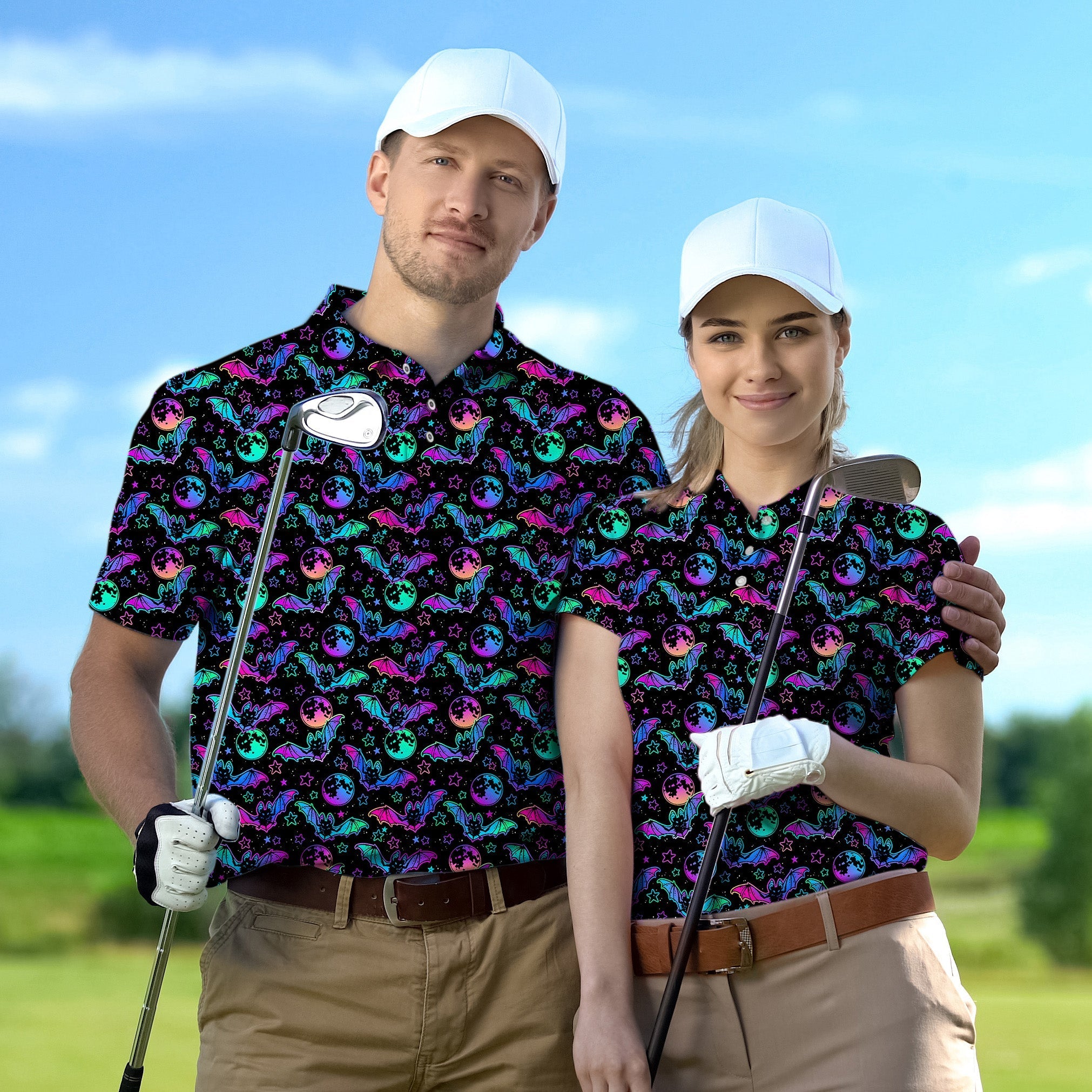 Couple wearing Halloween bat moon pattern golf shirts holding clubs on golf course