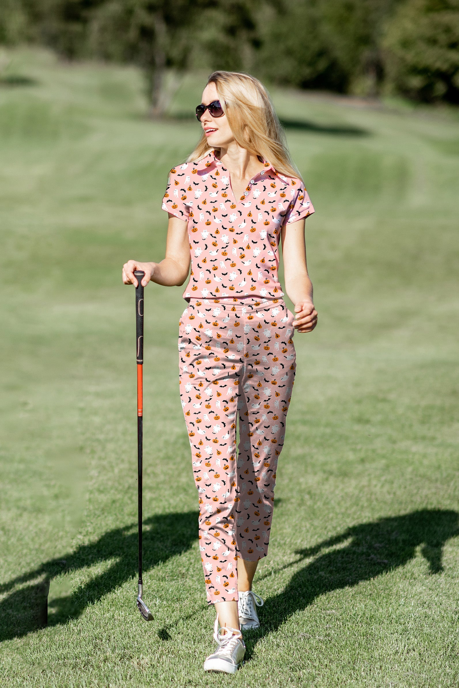 Women's golf polo and pants set with Halloween ghost and pumpkin print, four-way stretch, moisture-wicking fabric, UPF 40+ protection, and classic fit.