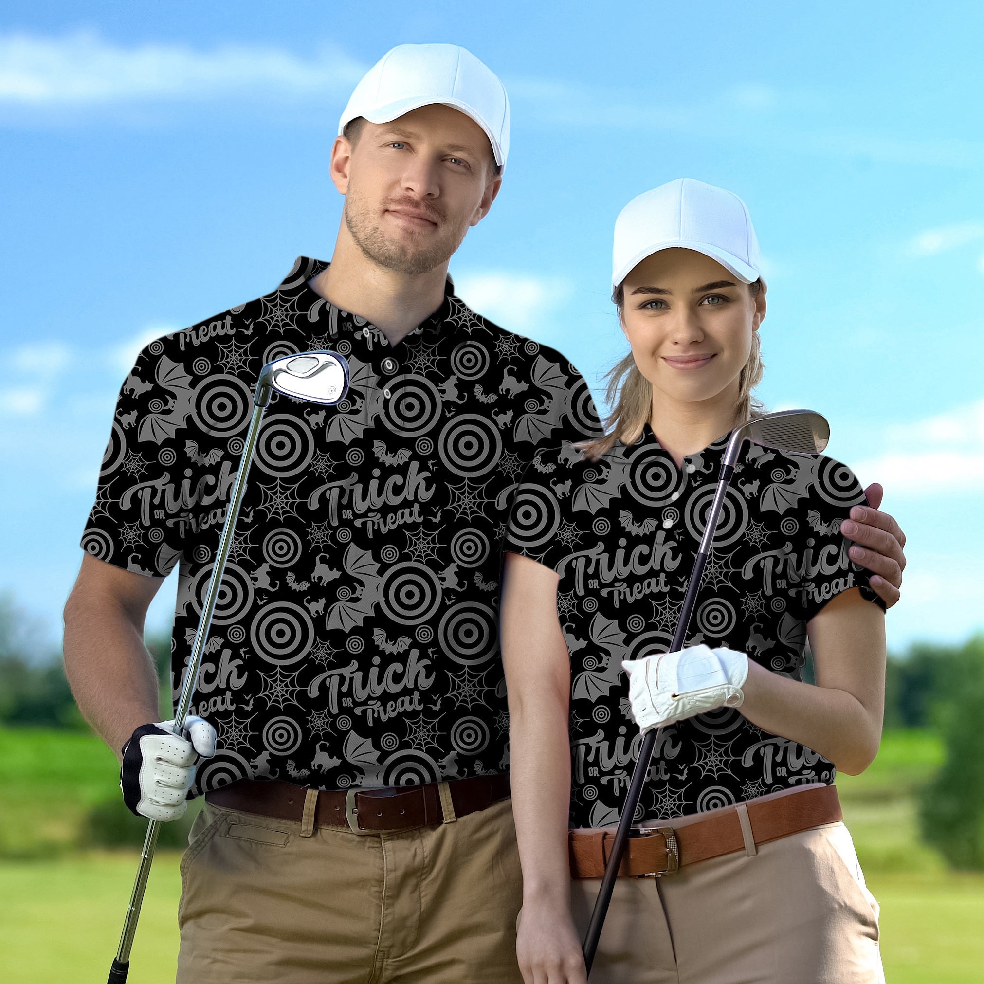 Couple wearing customized Halloween-themed golf shirts with circle, bat, and cat patterns on a golf course