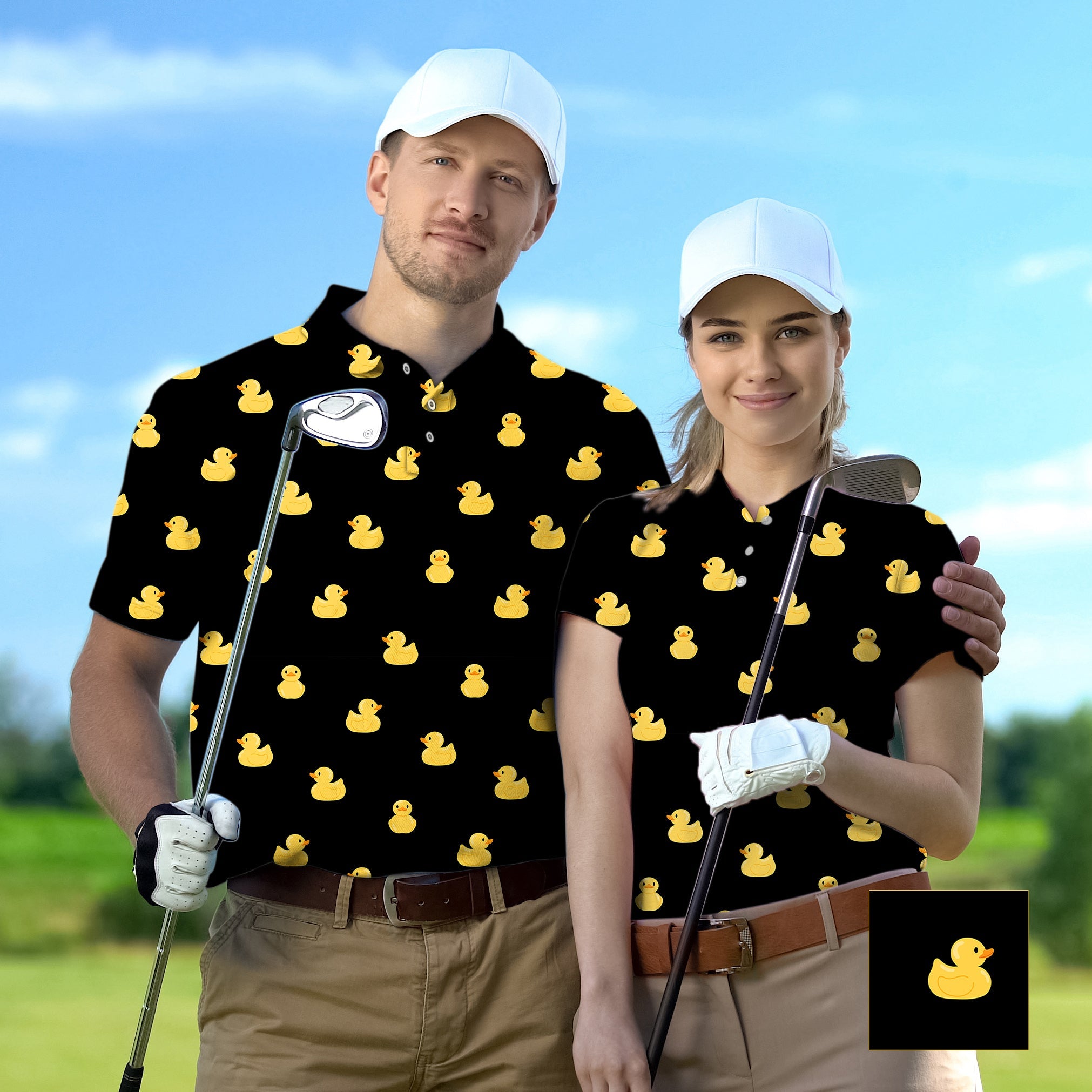 Couple wearing black golf shirts with yellow rubber duck pattern holding golf clubs outdoors
