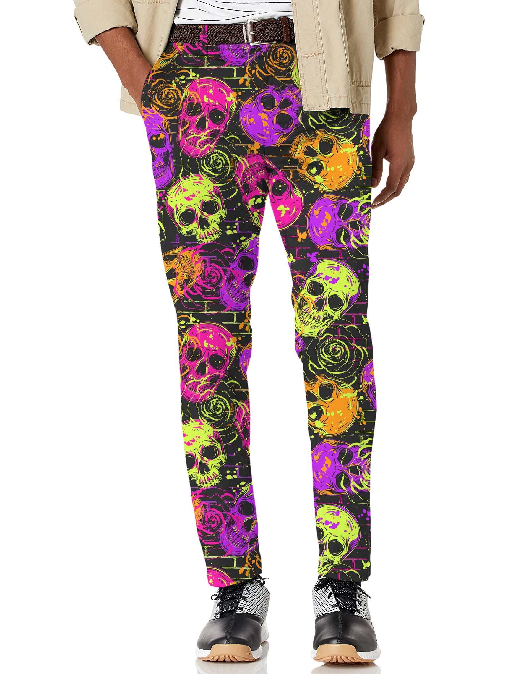 Men's Halloween colors skull print stretch golf pants in vibrant purple, green, and orange on black background