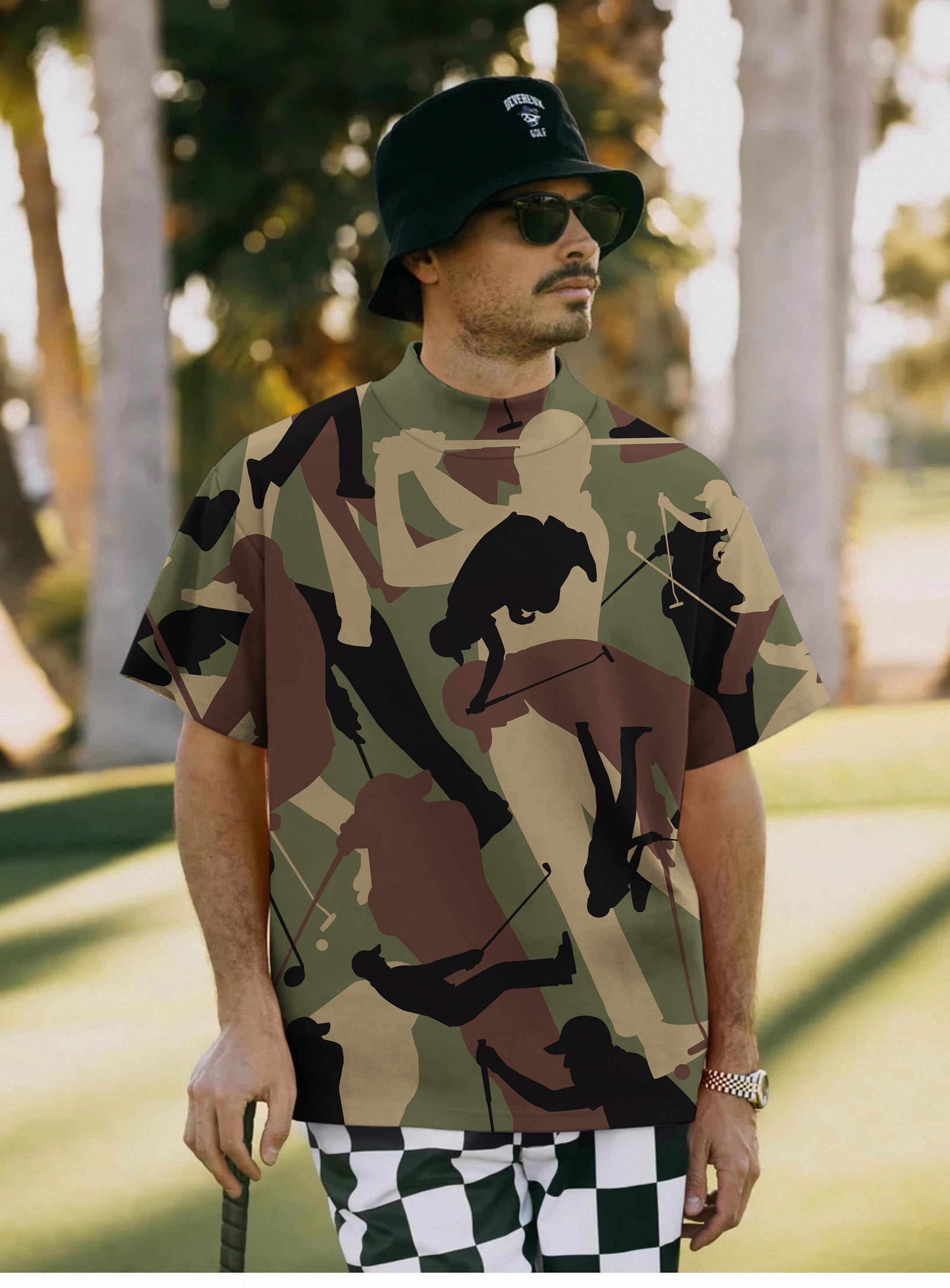 Men's Army Green Golf Pullover with golf player silhouettes and camouflage design worn by man outdoors