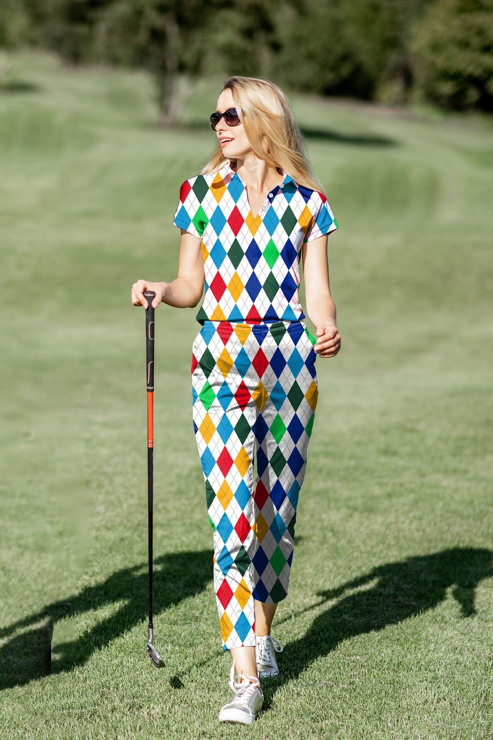 Women's golf polo and pants set with colorful argyle pattern, moisture-wicking fabric, and UPF 40+ protection