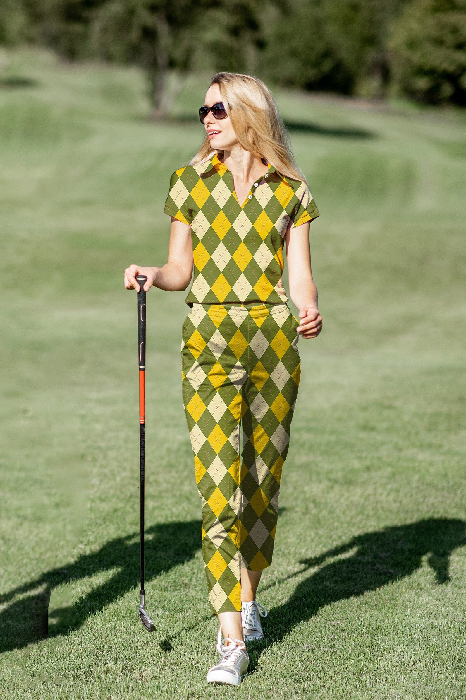 Women’s golf polo and pants set with yellow argyle pattern on golf course