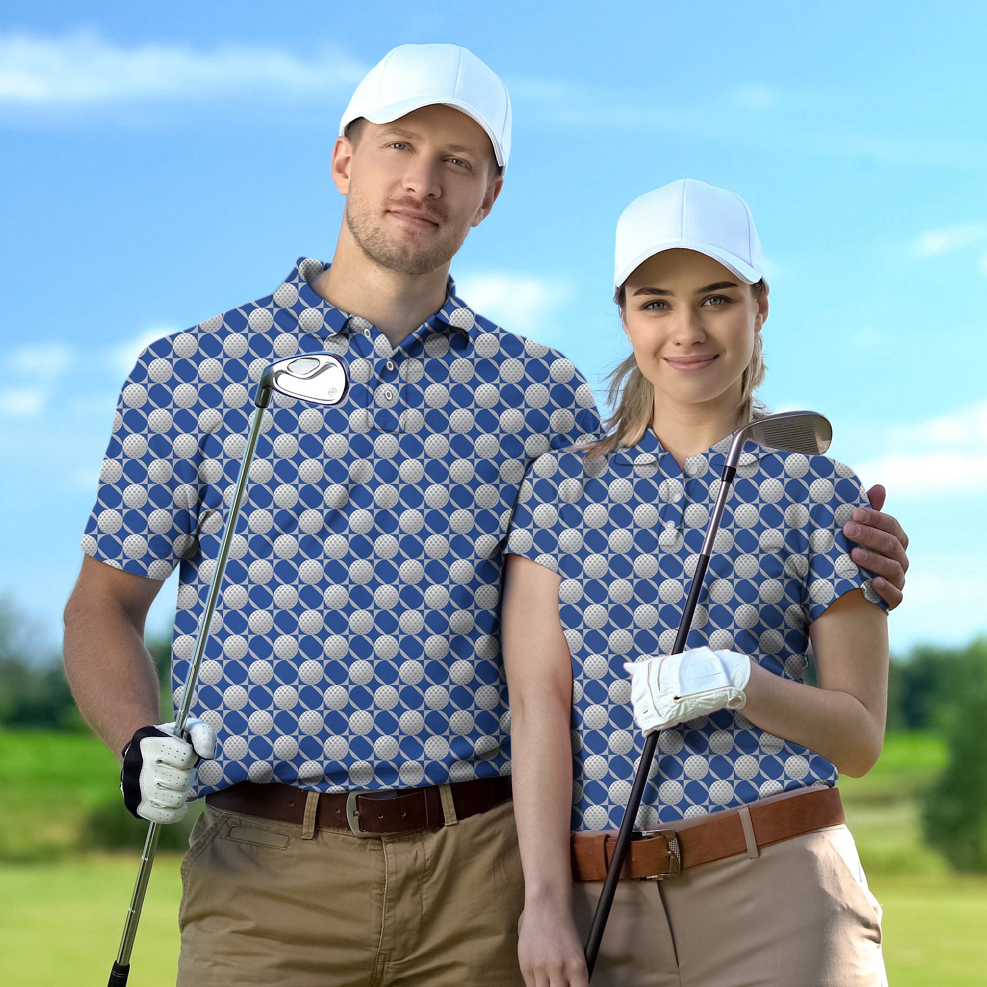 couple wearing blue golf ball patterned shirts holding golf clubs on course