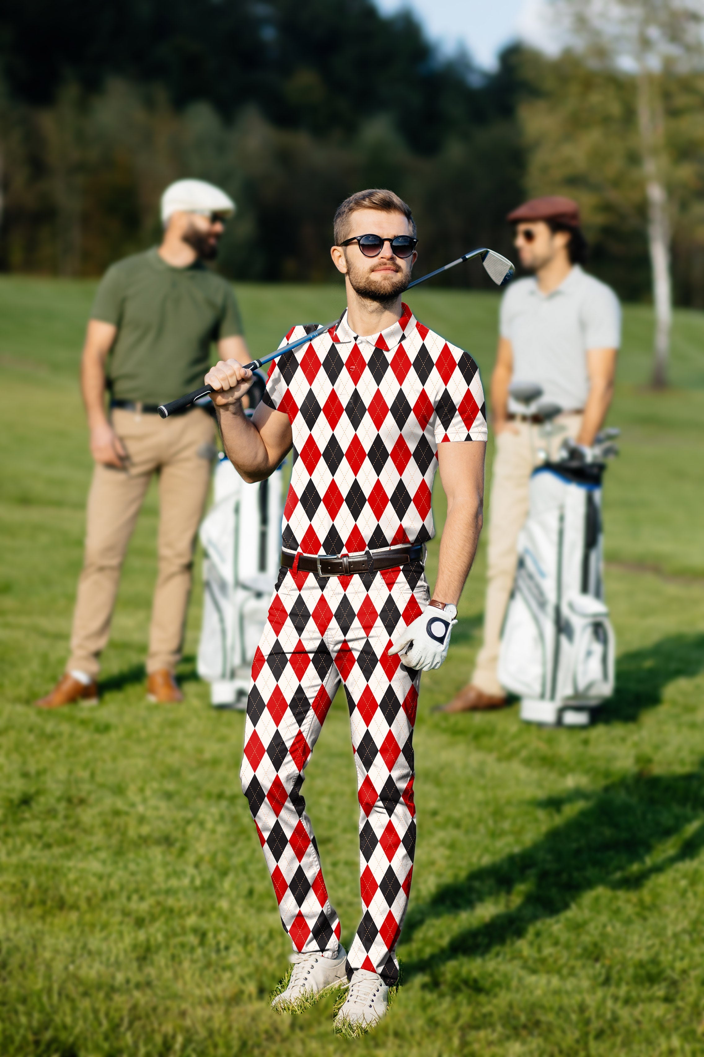 Men's golf set with argyle red and black grid polo and pants on golf course