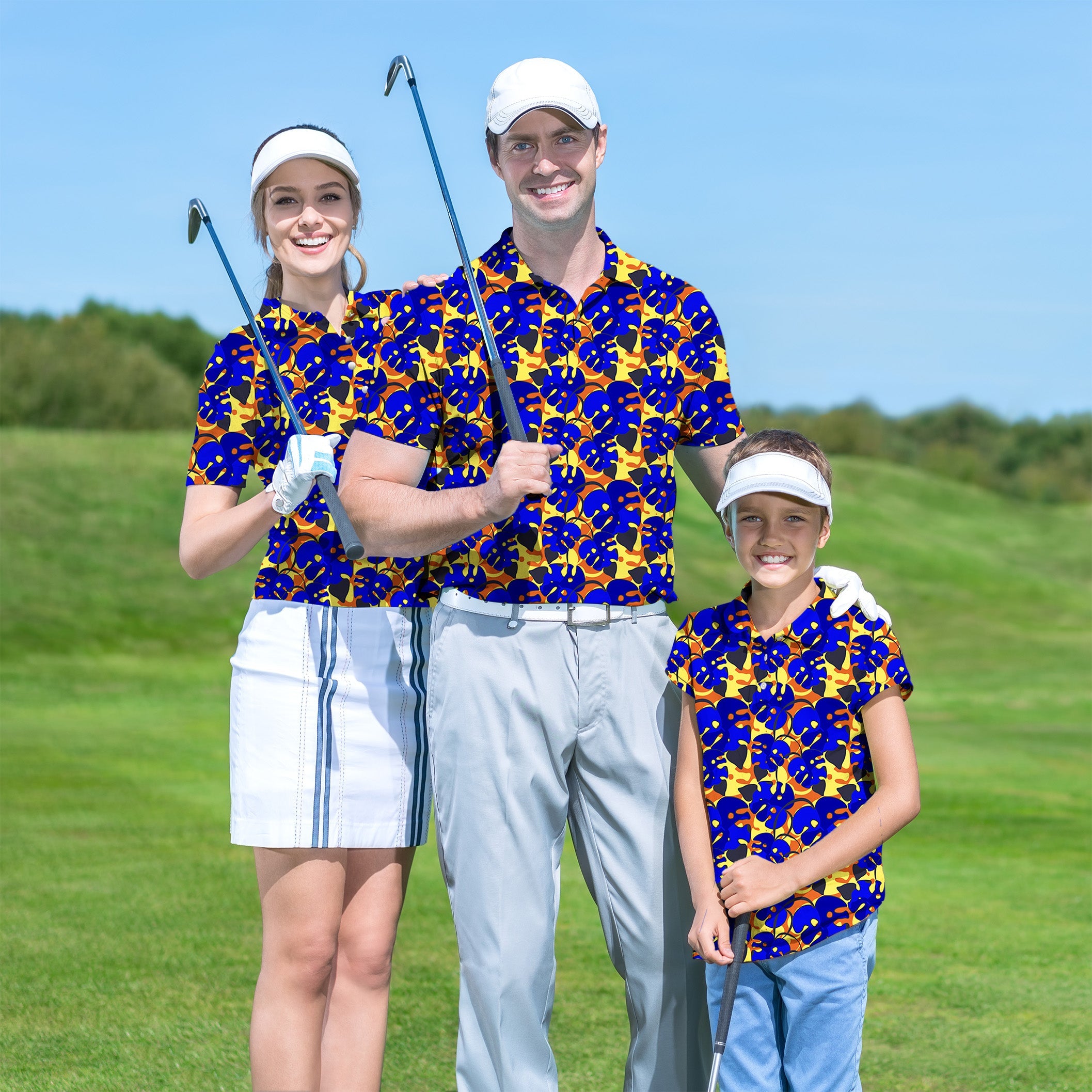 Family wearing matching tropical leaves golf shirts on course holding clubs