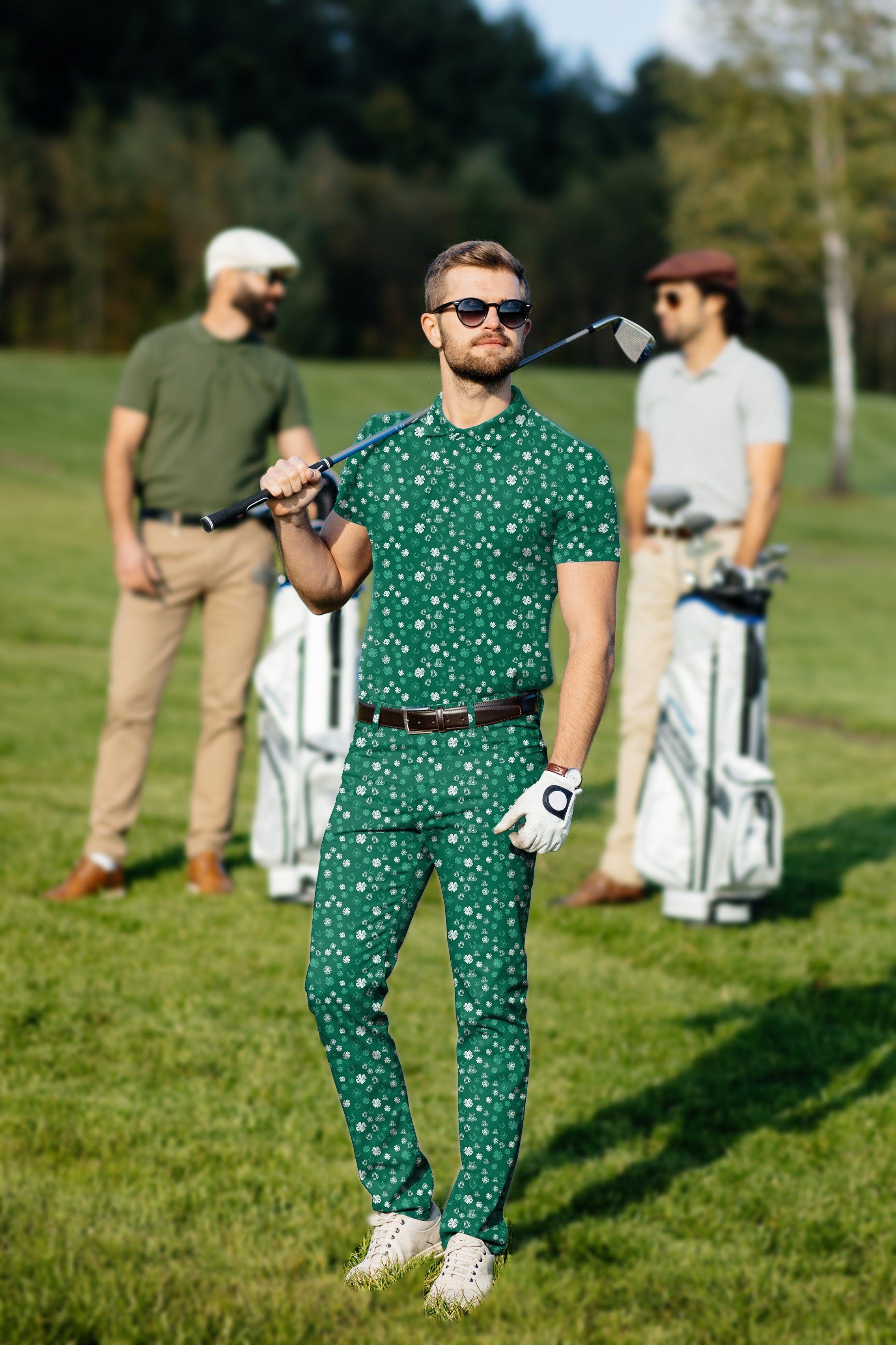 Men's green St. Patrick's Day golf polo and pants set with clover leaf pattern on the course