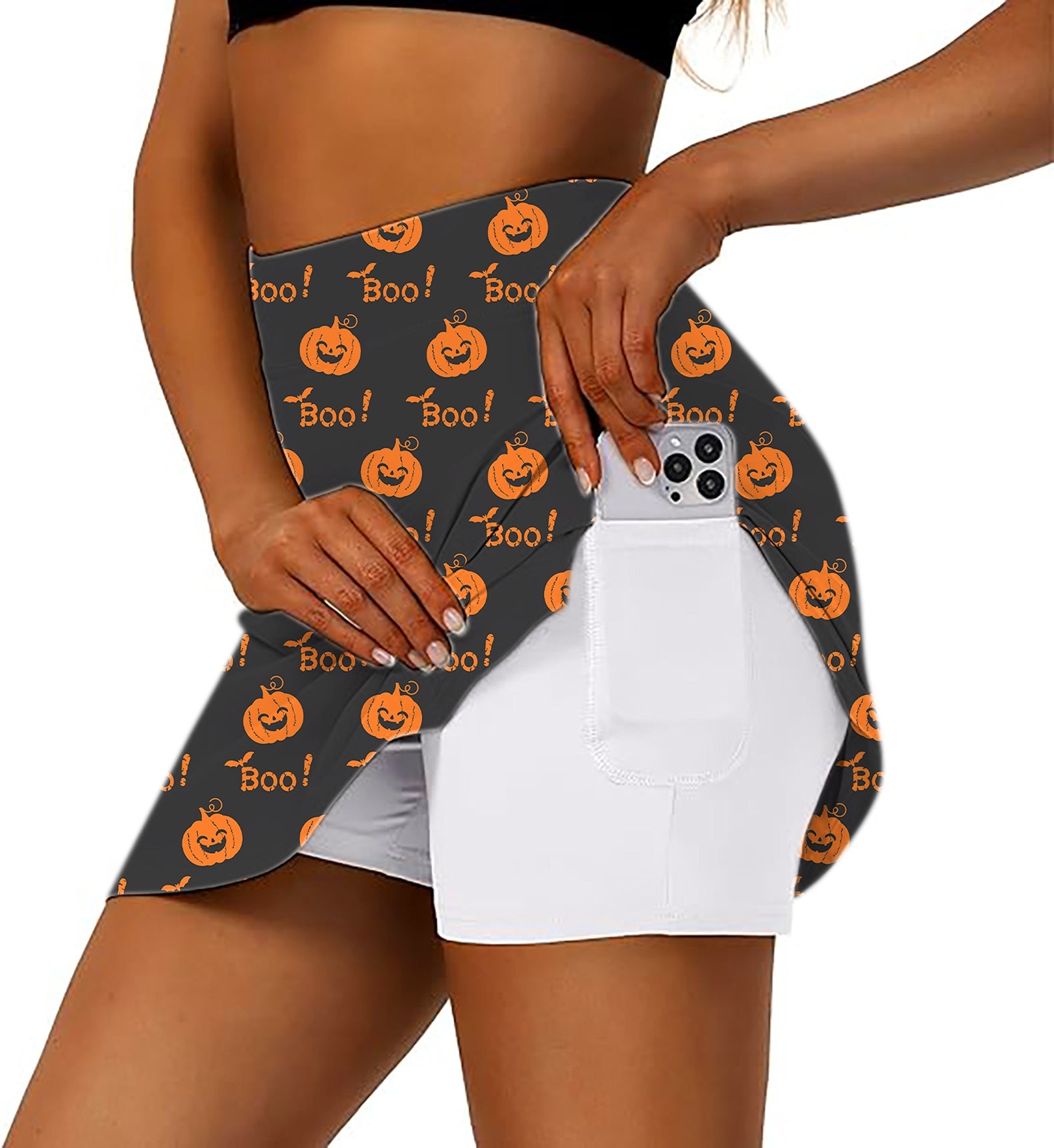Women’s Halloween Boo Pumpkin golf skirt with inner shorts and pocket holding phone