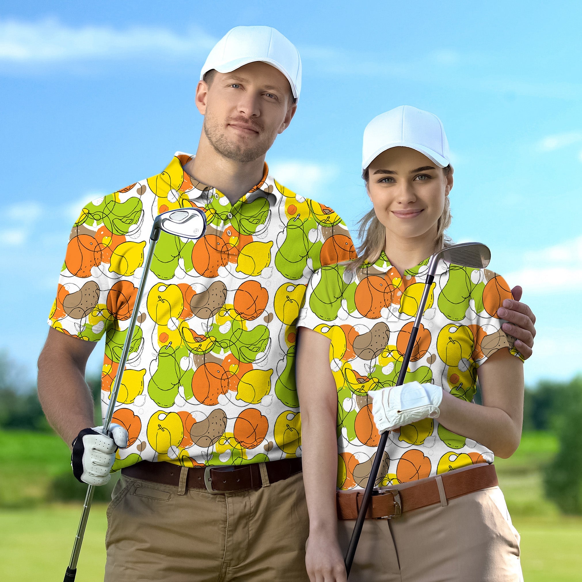 Couple wearing colorful fruit set golf shirts with white caps holding golf clubs on green course
