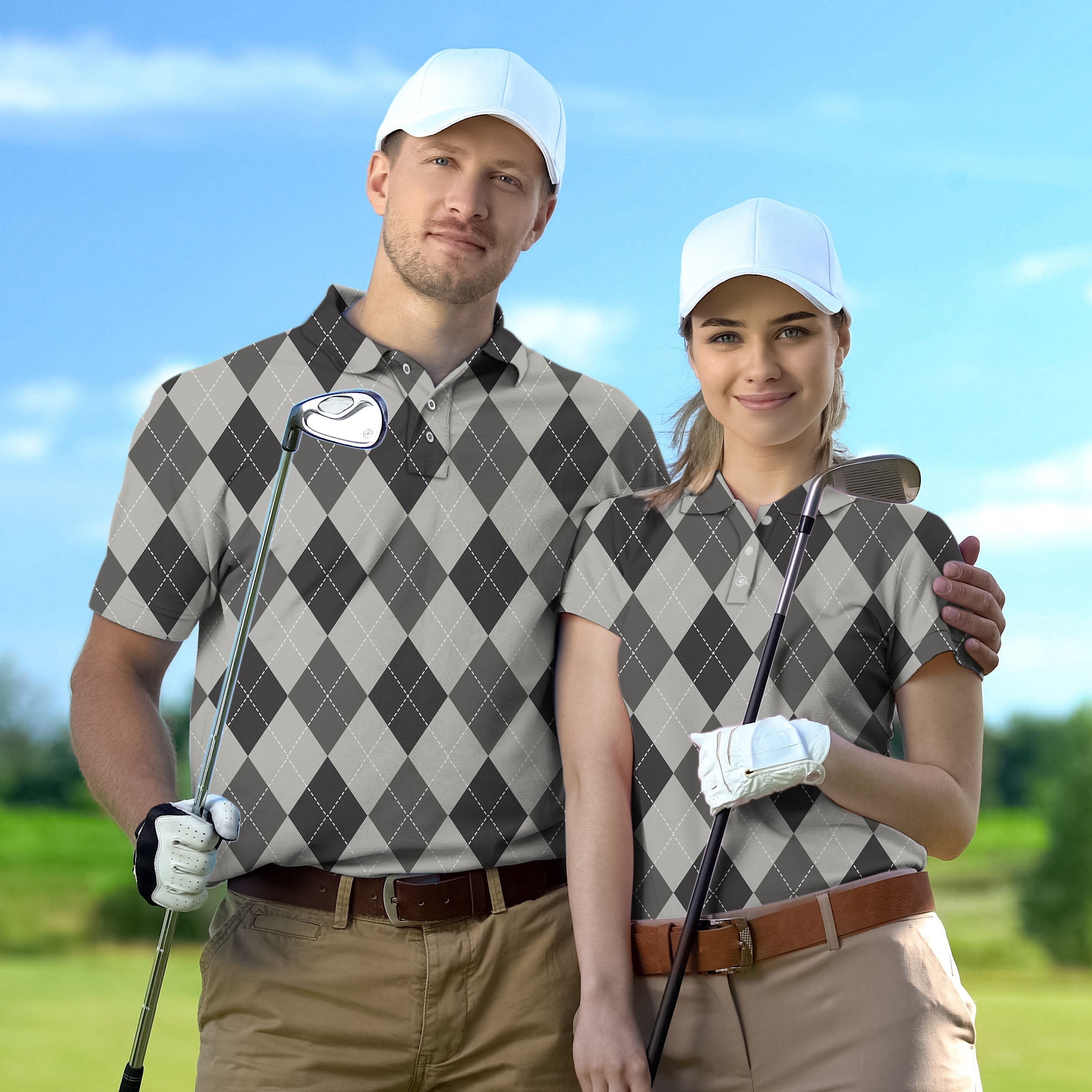 Couple wearing grey Argyle set golf shirts holding clubs on golf course