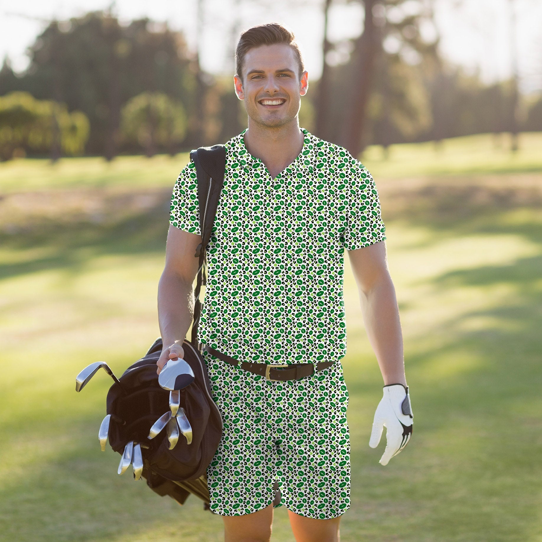 Man wearing green leopard print men's golf set polo and shorts carrying golf bag on course