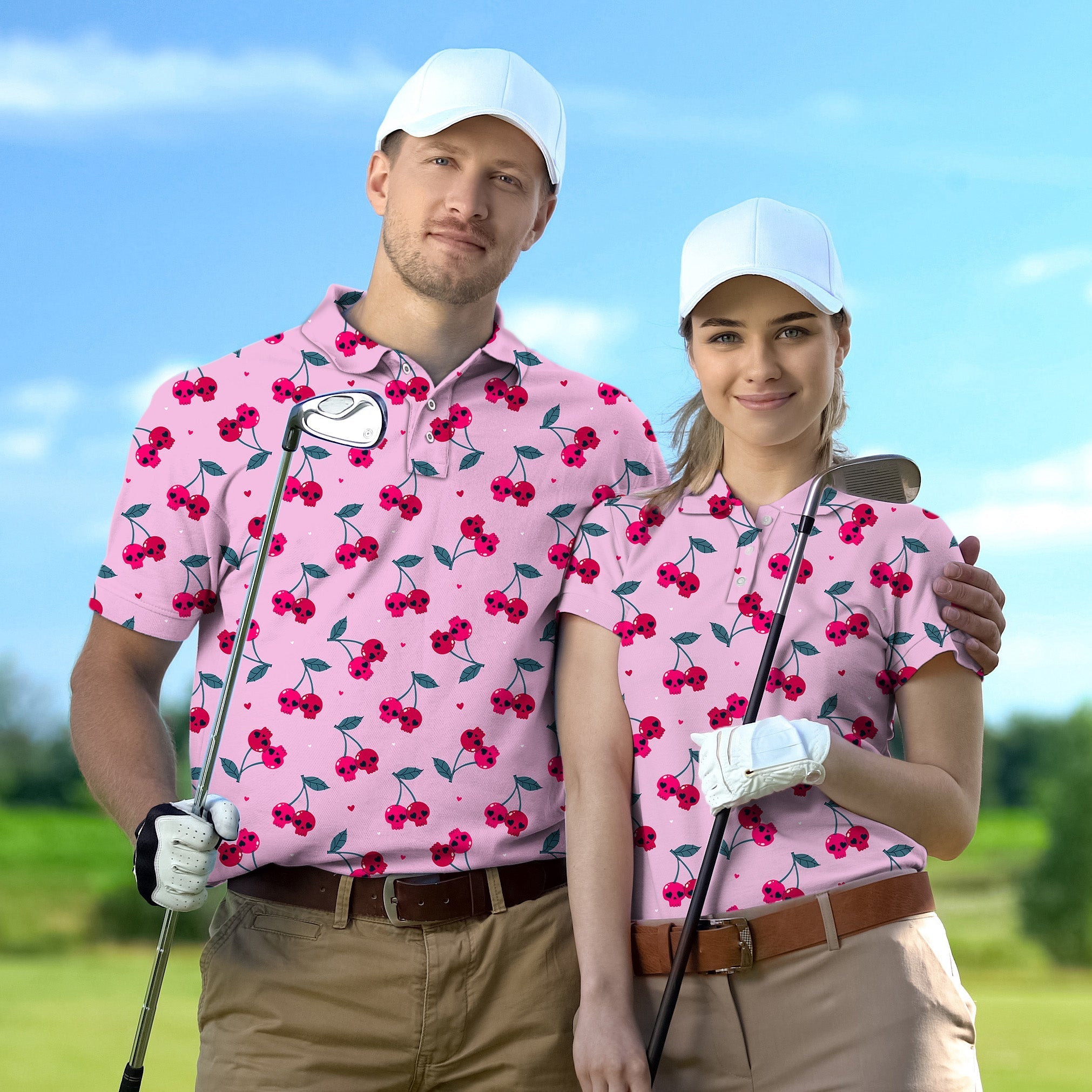 Couple wearing pink Halloween cherry skull golf shirts holding clubs on golf course