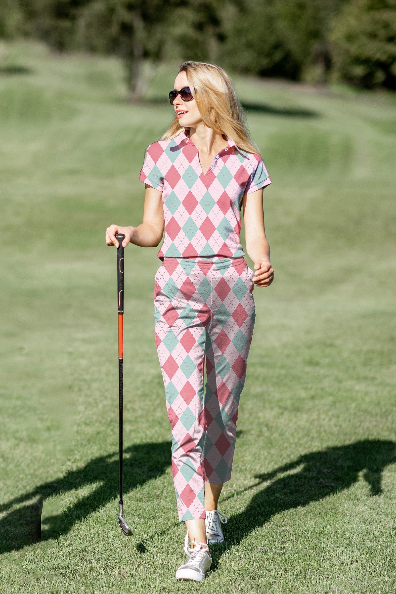 Women's golf polo and pants set in pink argyle pattern with four-way stretch and moisture-wicking fabric